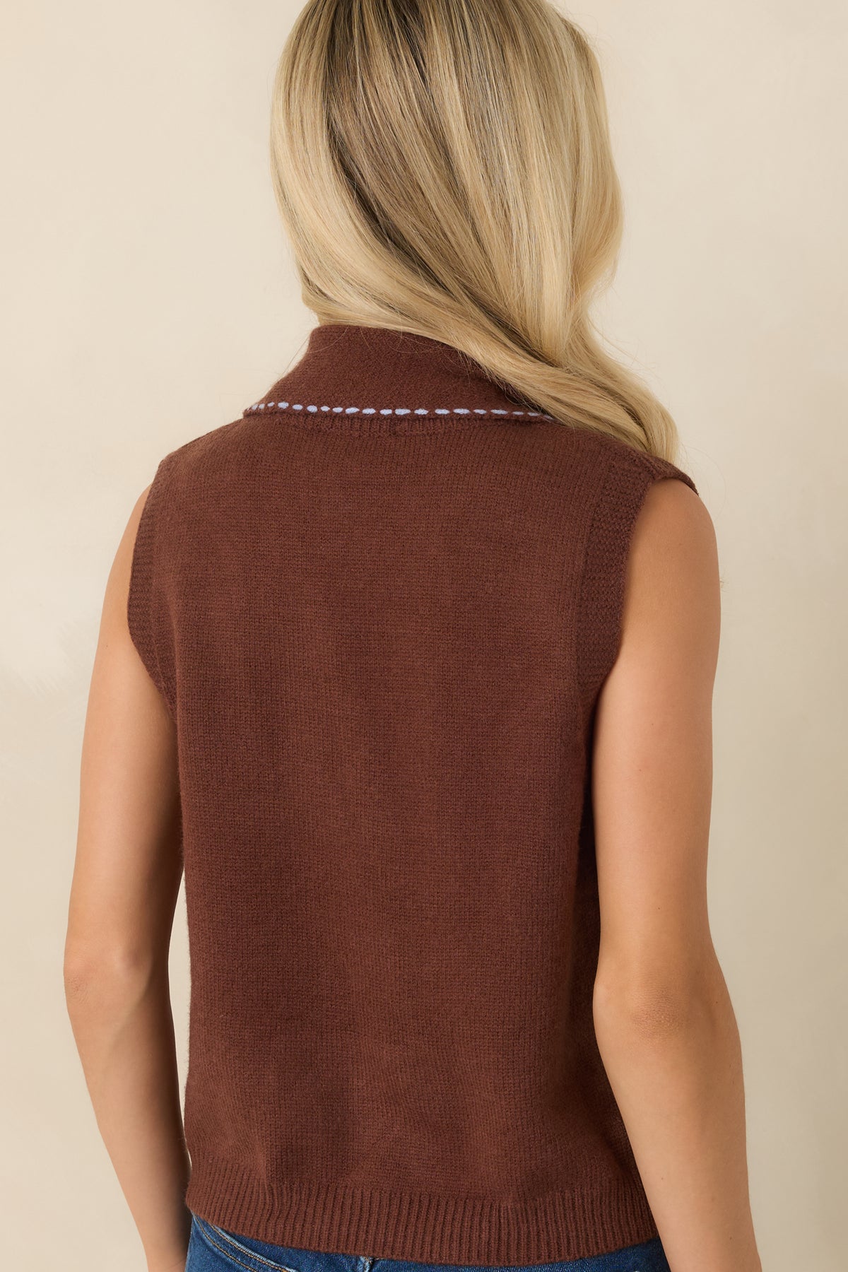 Back view of the sleeveless knit sweater featuring a clean silhouette, ribbed hem, and smooth soft knit finish.