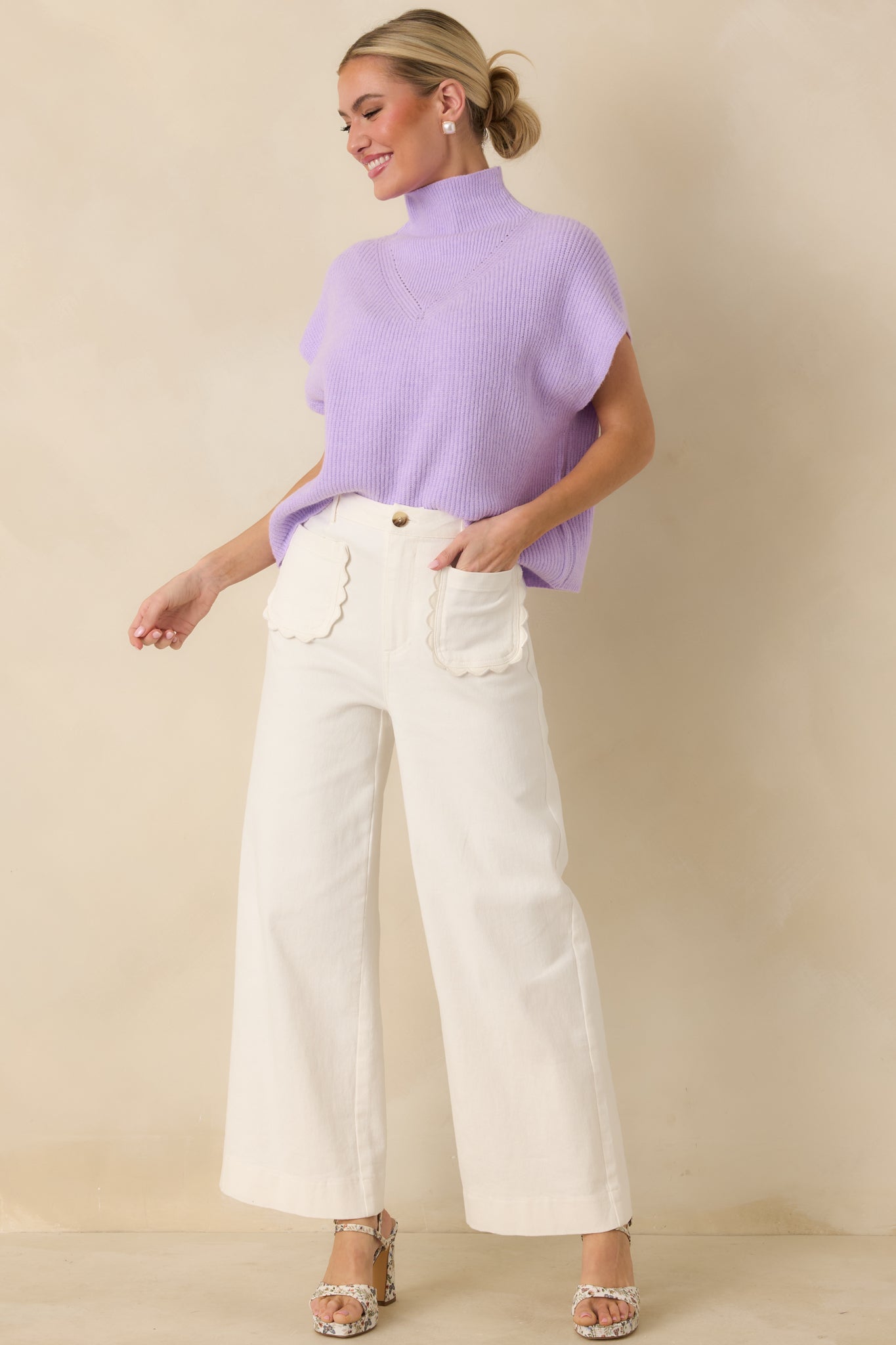 Sleeveless lavender sweater featuring subtle chest knit detailing and smooth hemline.