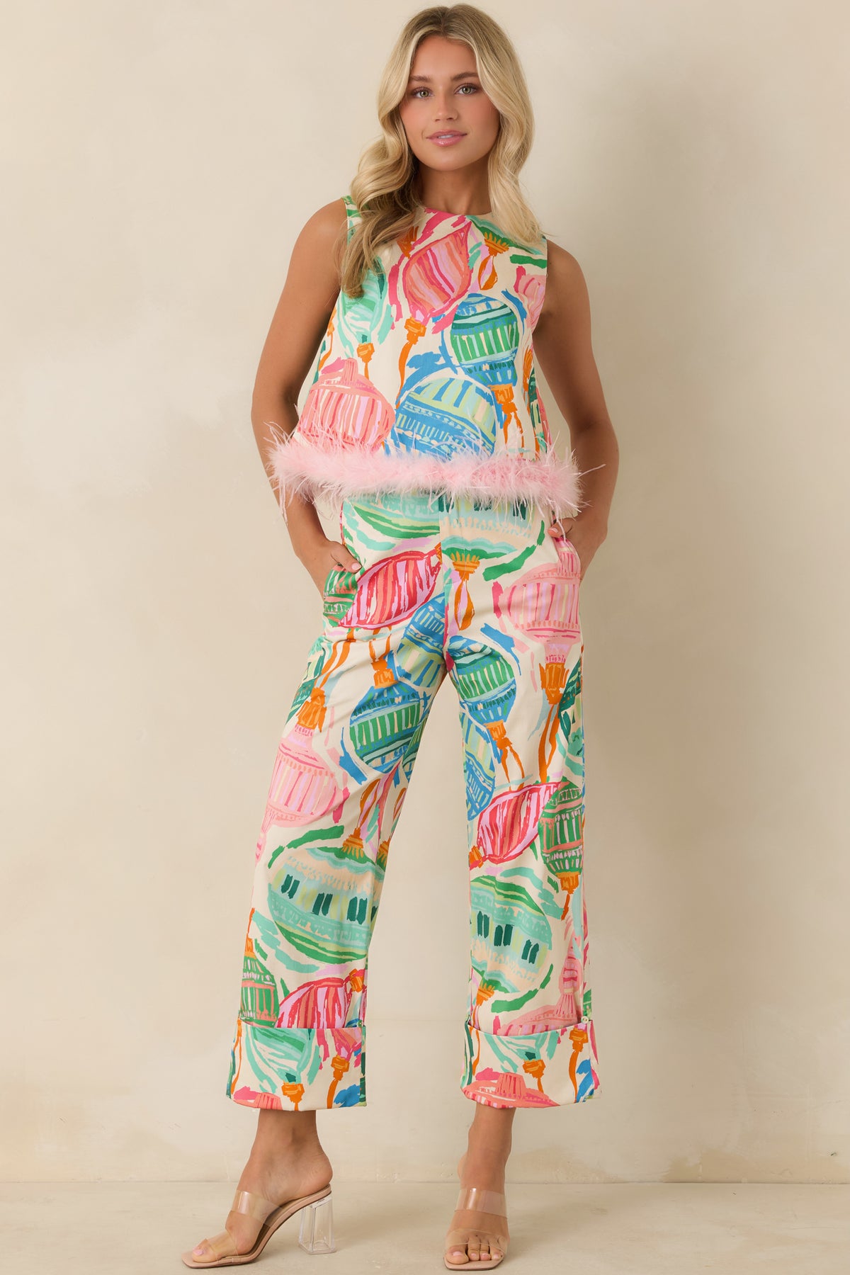 Sleeveless top with a colorful decorative ornament print and a fluffy feather-trimmed hem.