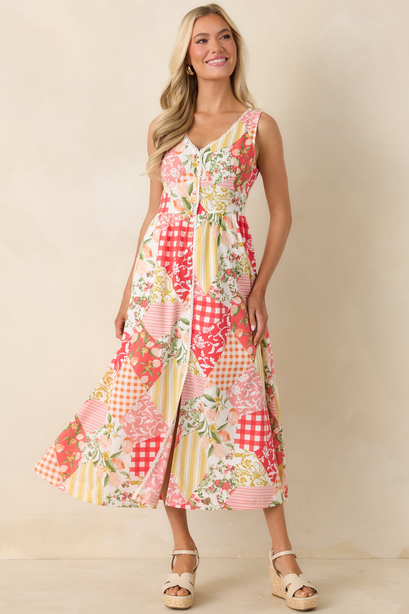 Sleeveless patchwork midi dress with decorative buttons, a smocked waistband, and a fully lined flowing skirt.