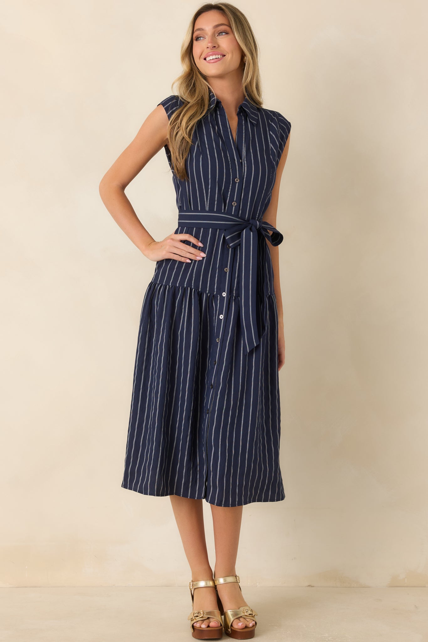 Sleeveless woven midi dress with an elongating stripe pattern, collared neckline, and removable self-tie belt.