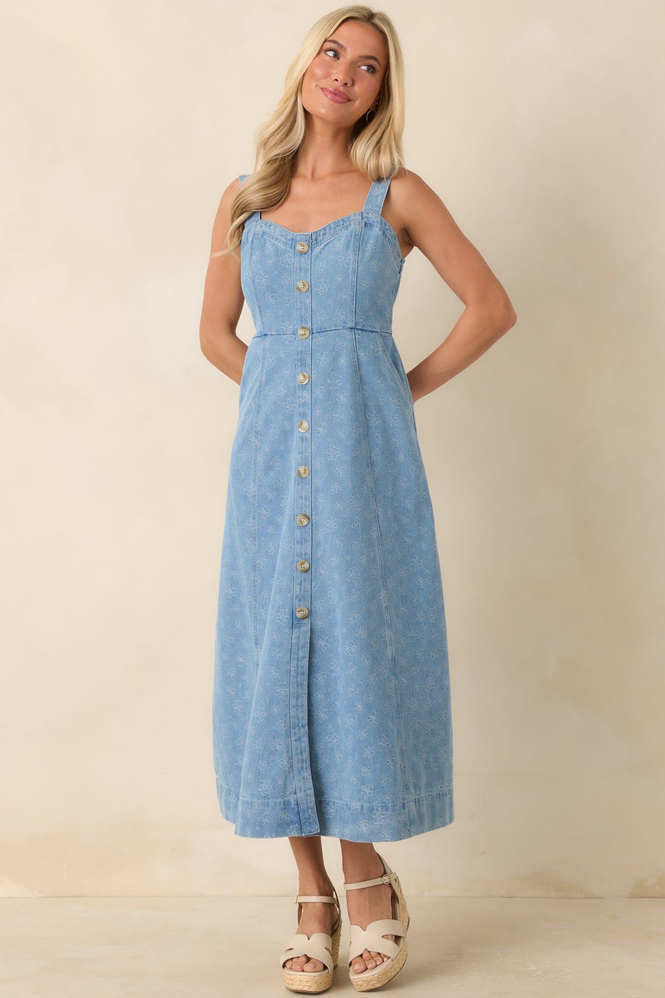 Sleeveless tonal floral dress with button detailing, comfortable fit, and easy silhouette.
