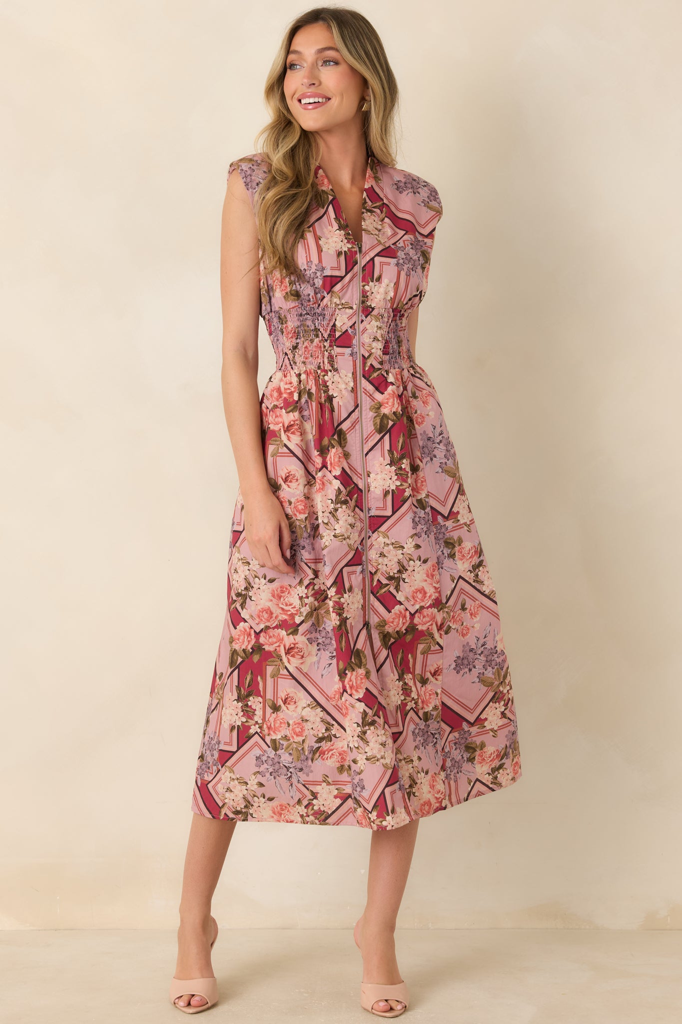 Sleeveless cotton midi dress showcasing a V-neck, full-length front zipper, defined smocked waist, and relaxed flowy skirt.