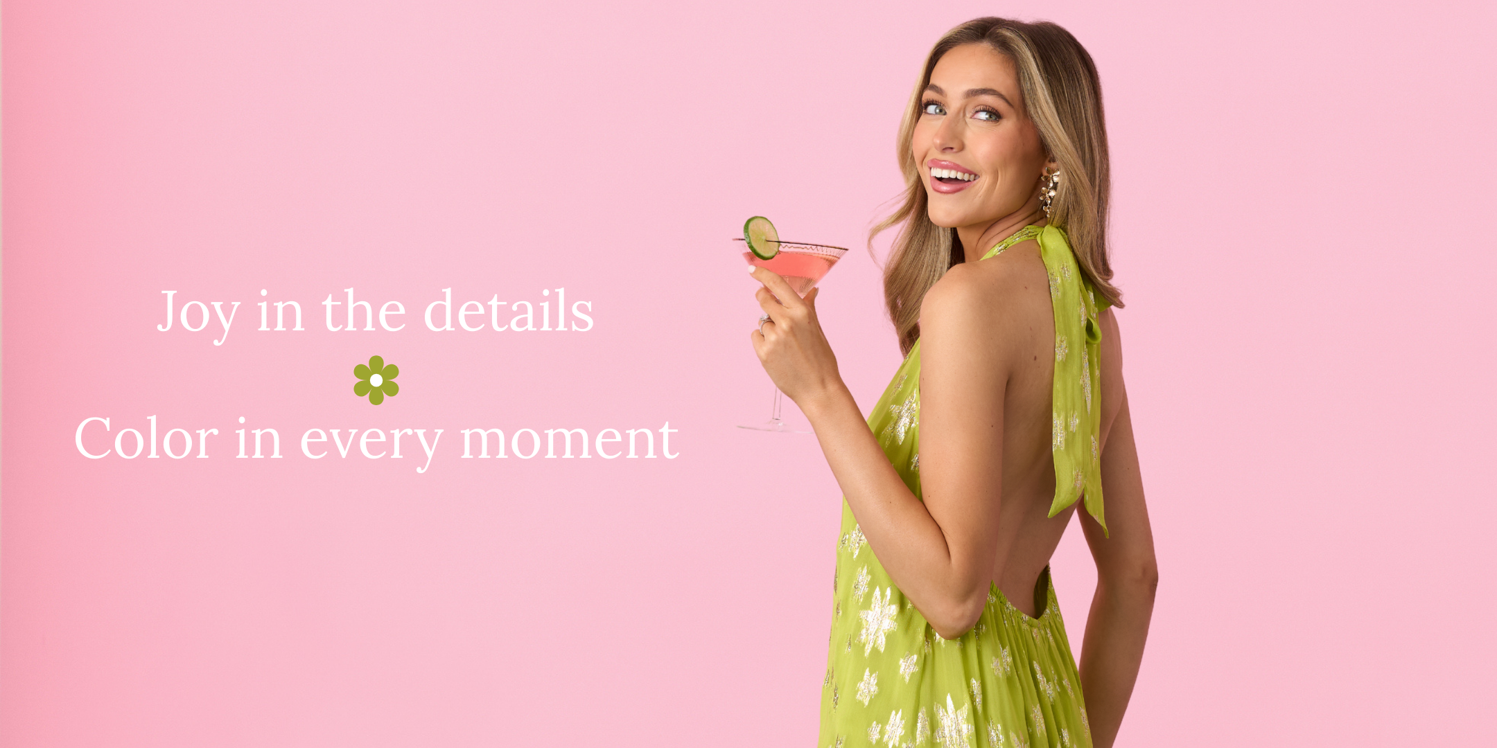 Woman in a green dress holding a pink drink against a pink background with text.