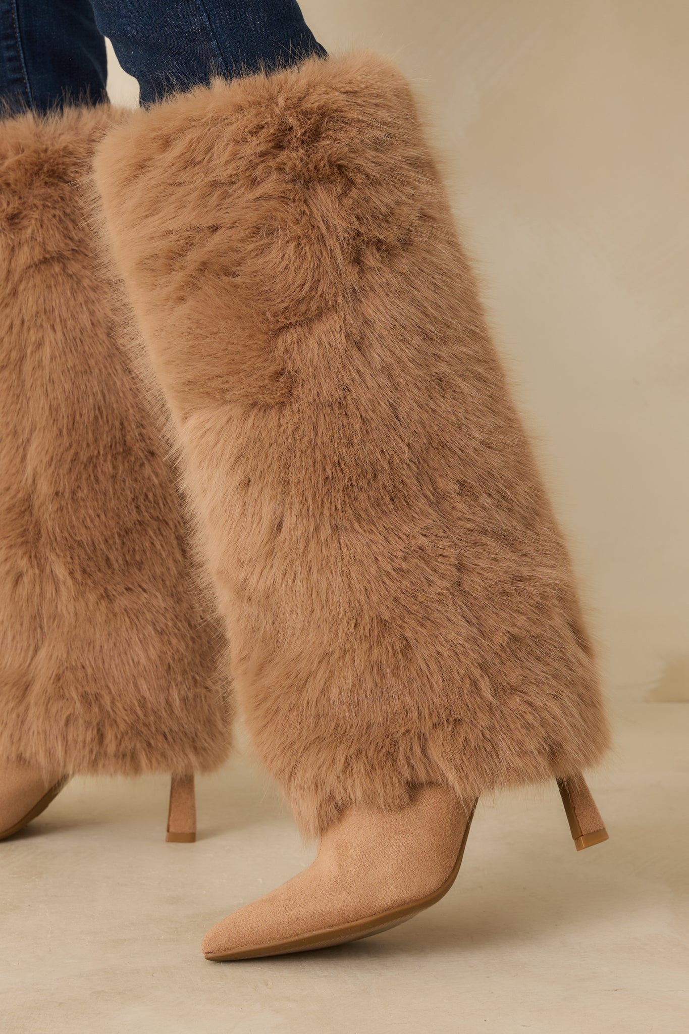 Cropped image highlighting the slim stiletto heel and the clean transition from suede footbed to fur shaft.