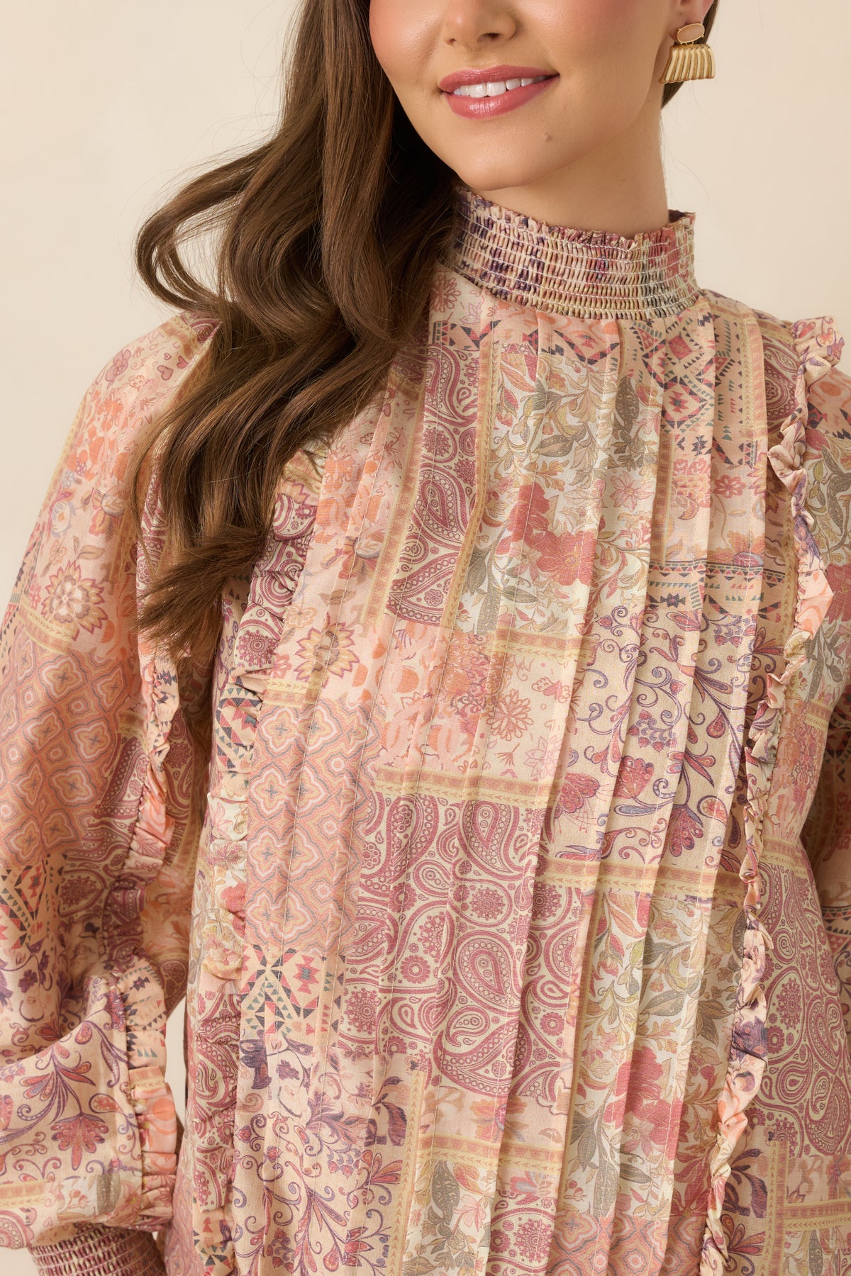 Smocked high neckline with pintucks and delicate ruffle trim.
