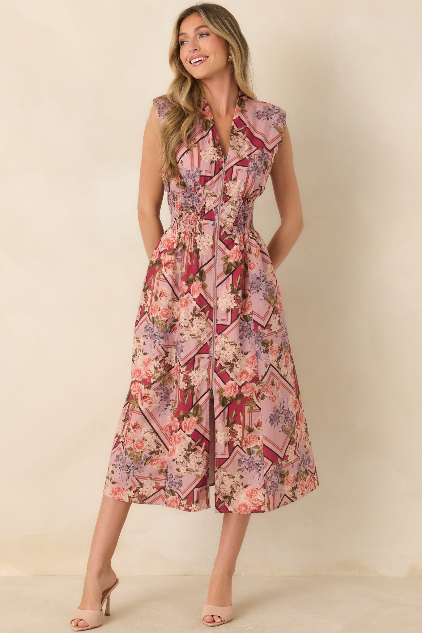 100% cotton dress designed with a flattering smocked waist, sleeveless cut, V-neckline, and full midi skirt for an easy, flowing silhouette.
