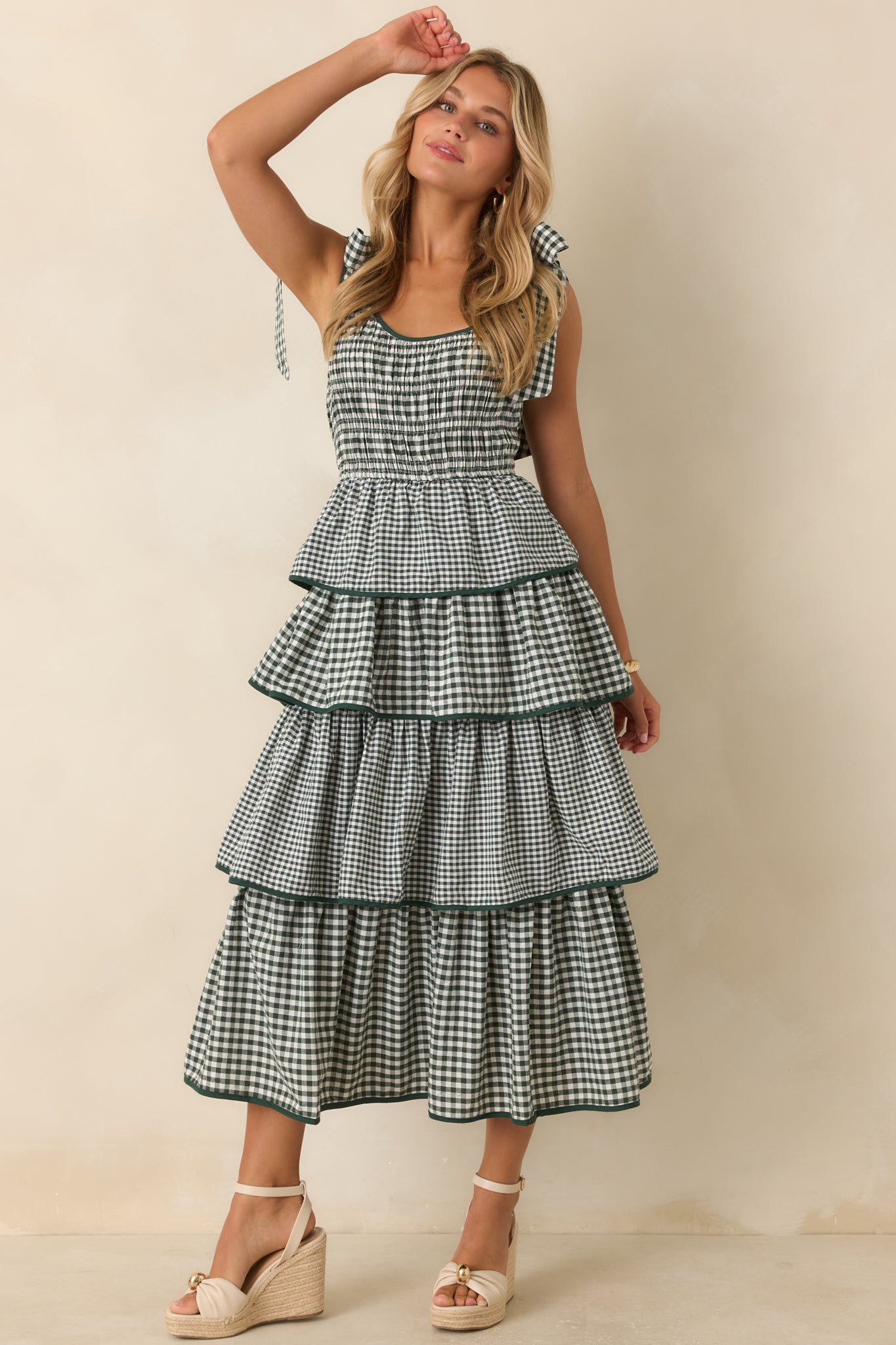 Smocked waist dress with fixed shoulder ties, layered skirt tiers, and an effortless flowing silhouette.