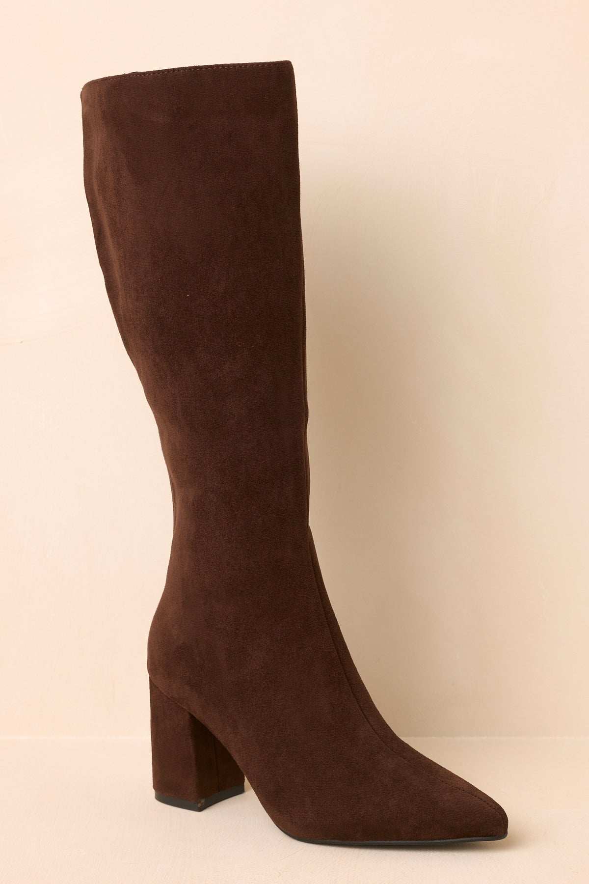 Smooth faux suede knee-high boots with a streamlined shaft and substantial covered block heel.