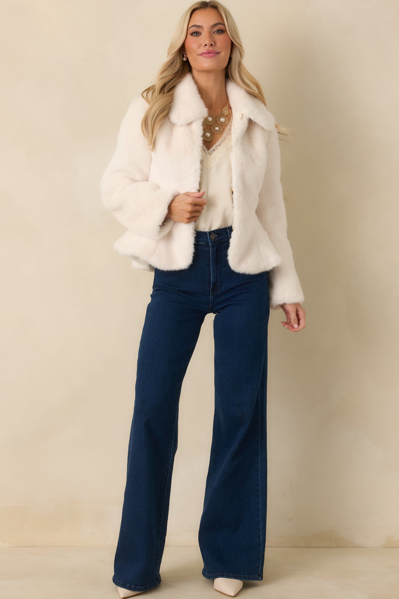 Smooth ivory faux fur coat showing a streamlined shape with long sleeves and a polished, minimal look.