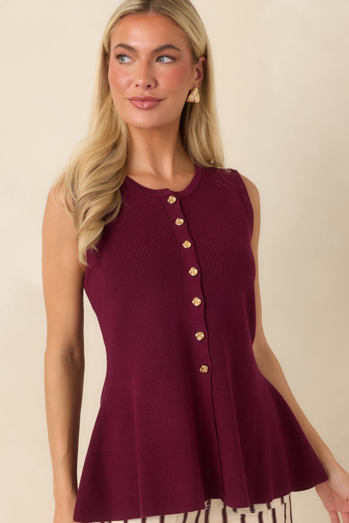 Zoomed-in look at the smooth knit fabric and softly flared hem that define the top's classic silhouette.