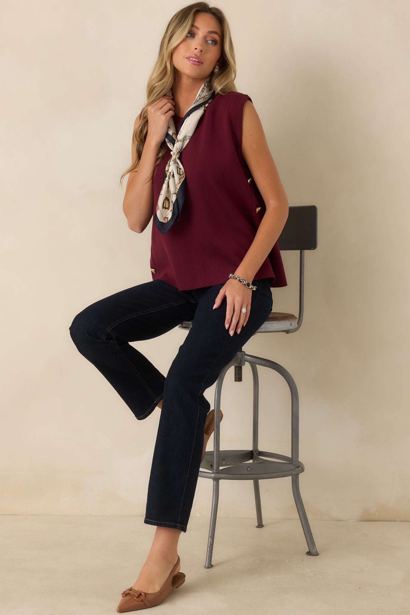 Smooth knit top with a breathable feel, elegant drape, and modern gold-tone buttons along the side.