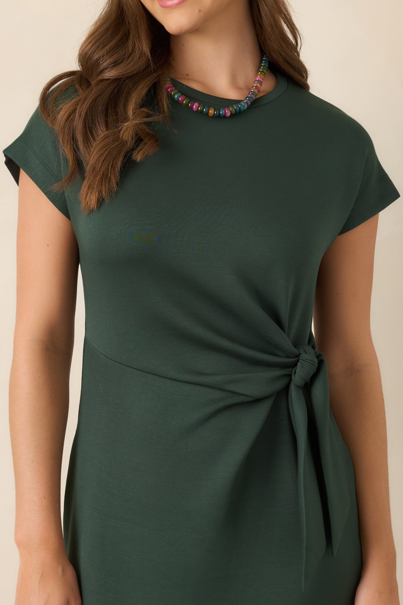 Close view of the smooth rayon-blend fabric and waist knot, highlighting the buttery texture and softly gathered definition.