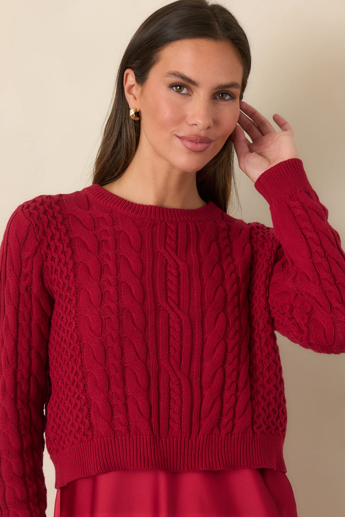 Cropped view highlighting the contrast between the smooth satin dress and textured cotton sweater.