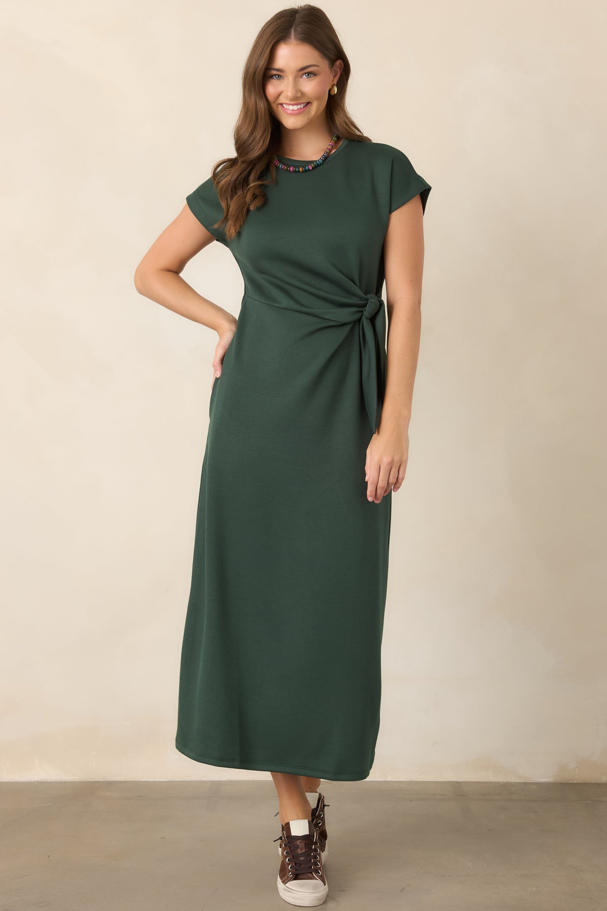 Smooth stretch dress with a fluid midi silhouette, comfortable fit, and sculpted waist knot adding gentle definition through the center.