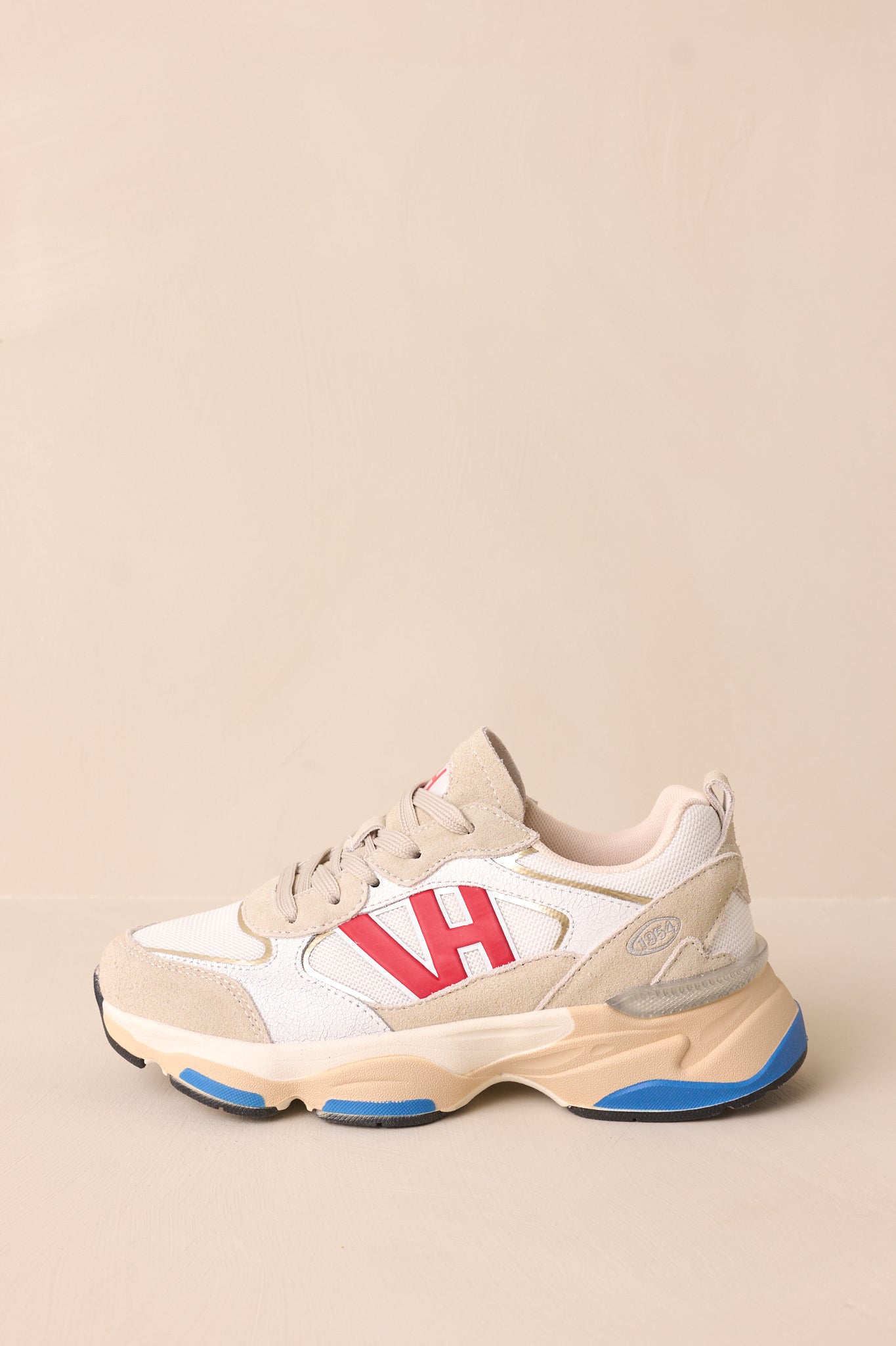 Cropped side detail highlighting the red VH symbol, beige sole, and grey-beige panels.