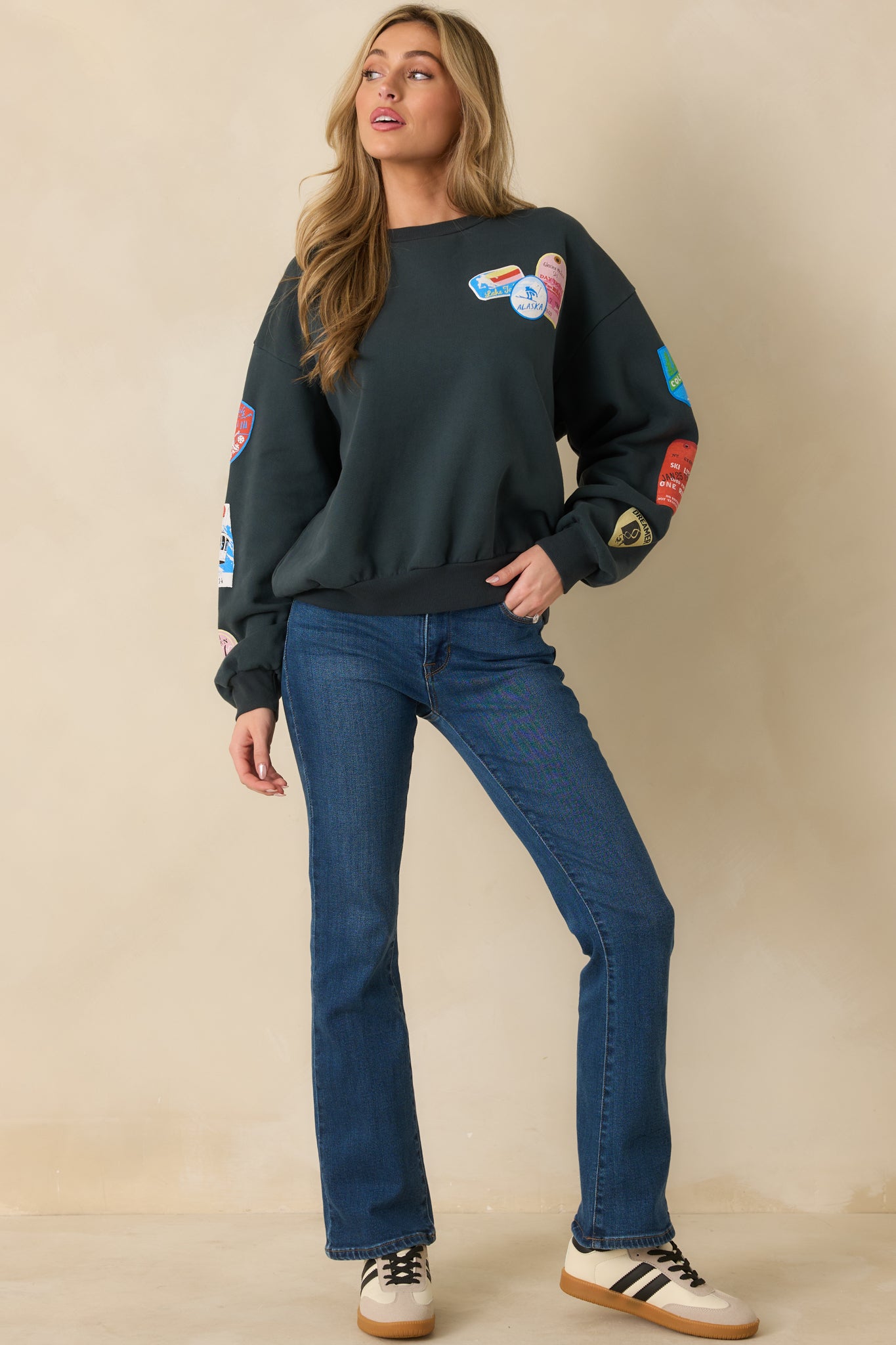 Soft black fleece sweatshirt featuring its bright ski-themed patches and easy fit.