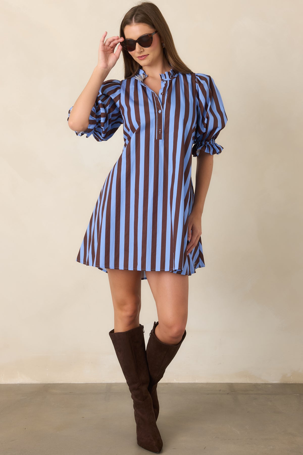 Soft blue and rich brown striped cotton mini dress featuring a ruffled mock collar, partial button-front placket, voluminous three-quarter puff sleeves, and relaxed shift silhouette.