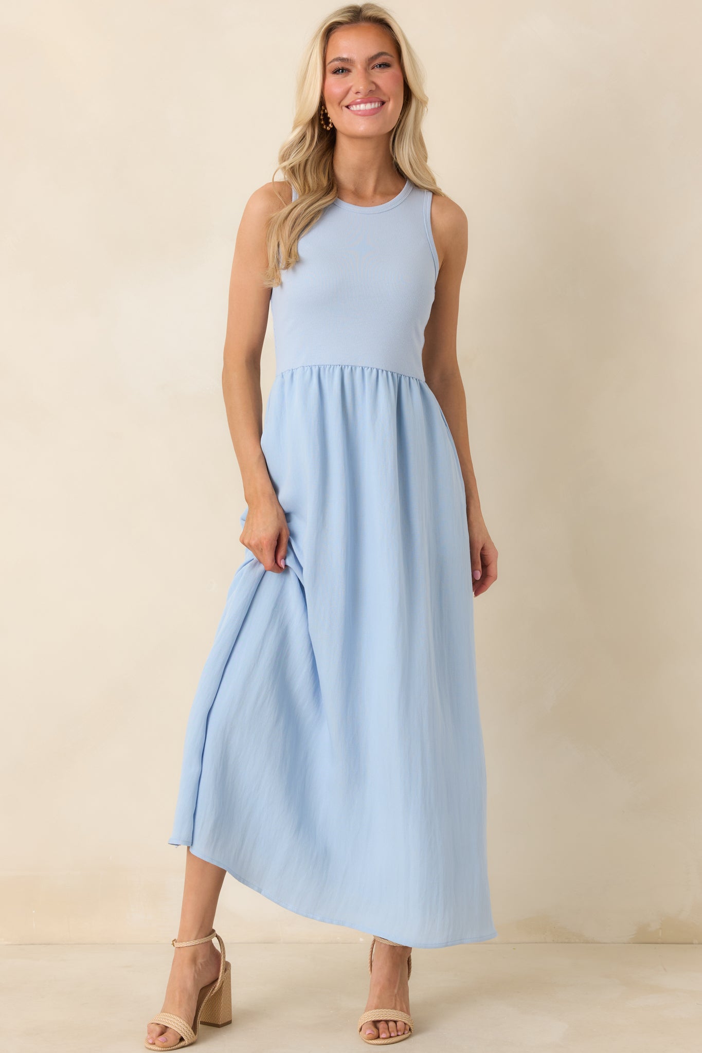 Midi-length dress in soft blue with a sleeveless ribbed bodice and flowy textured skirt.