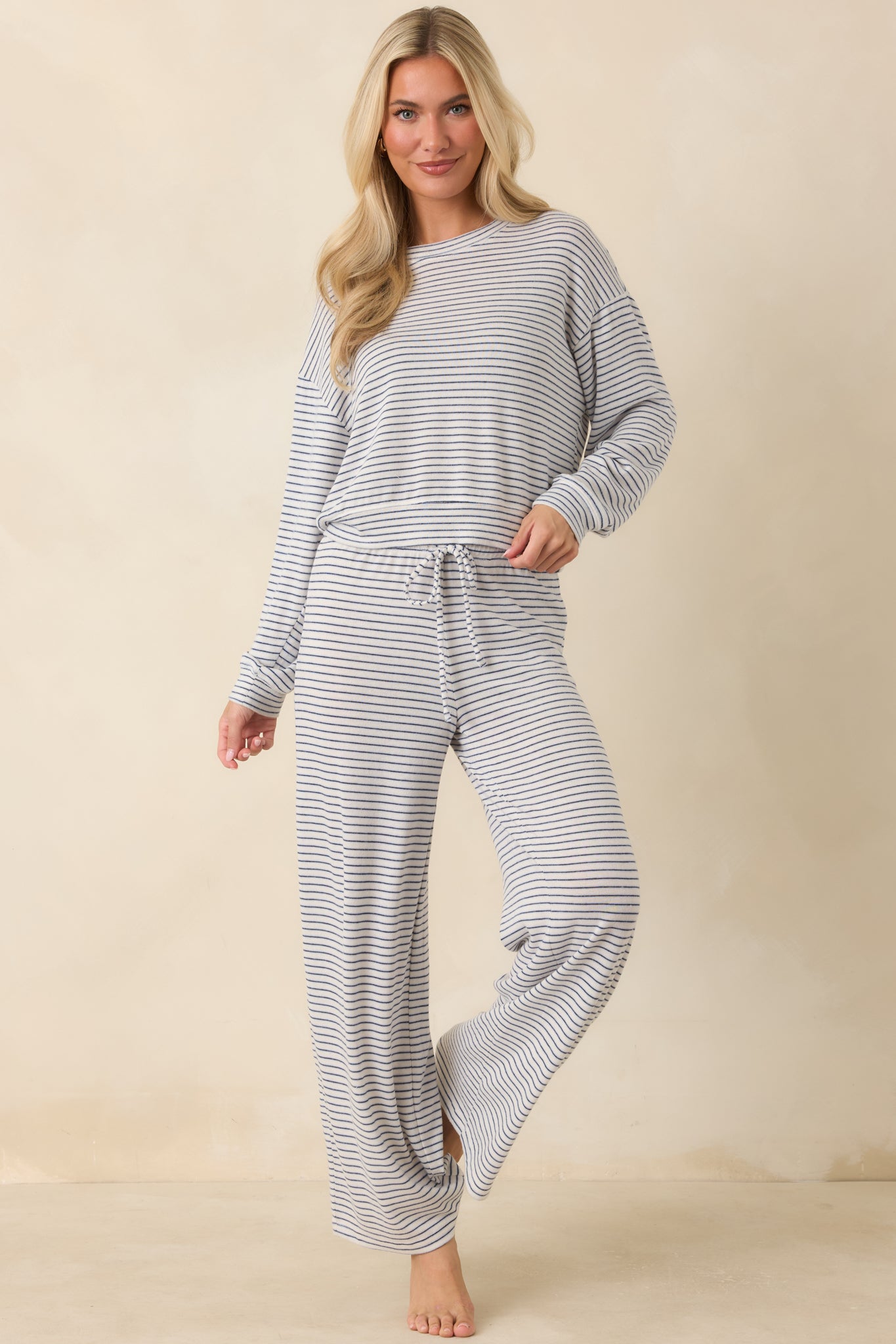 Soft brushed sweater knit top with long sleeves, a cozy silhouette, and classic navy stripes