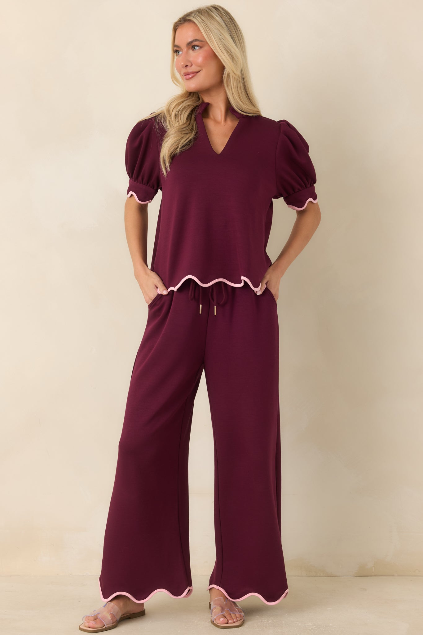Soft burgundy top with a relaxed silhouette, puff sleeves, and delicate blush pink accents that elevate its timeless design.