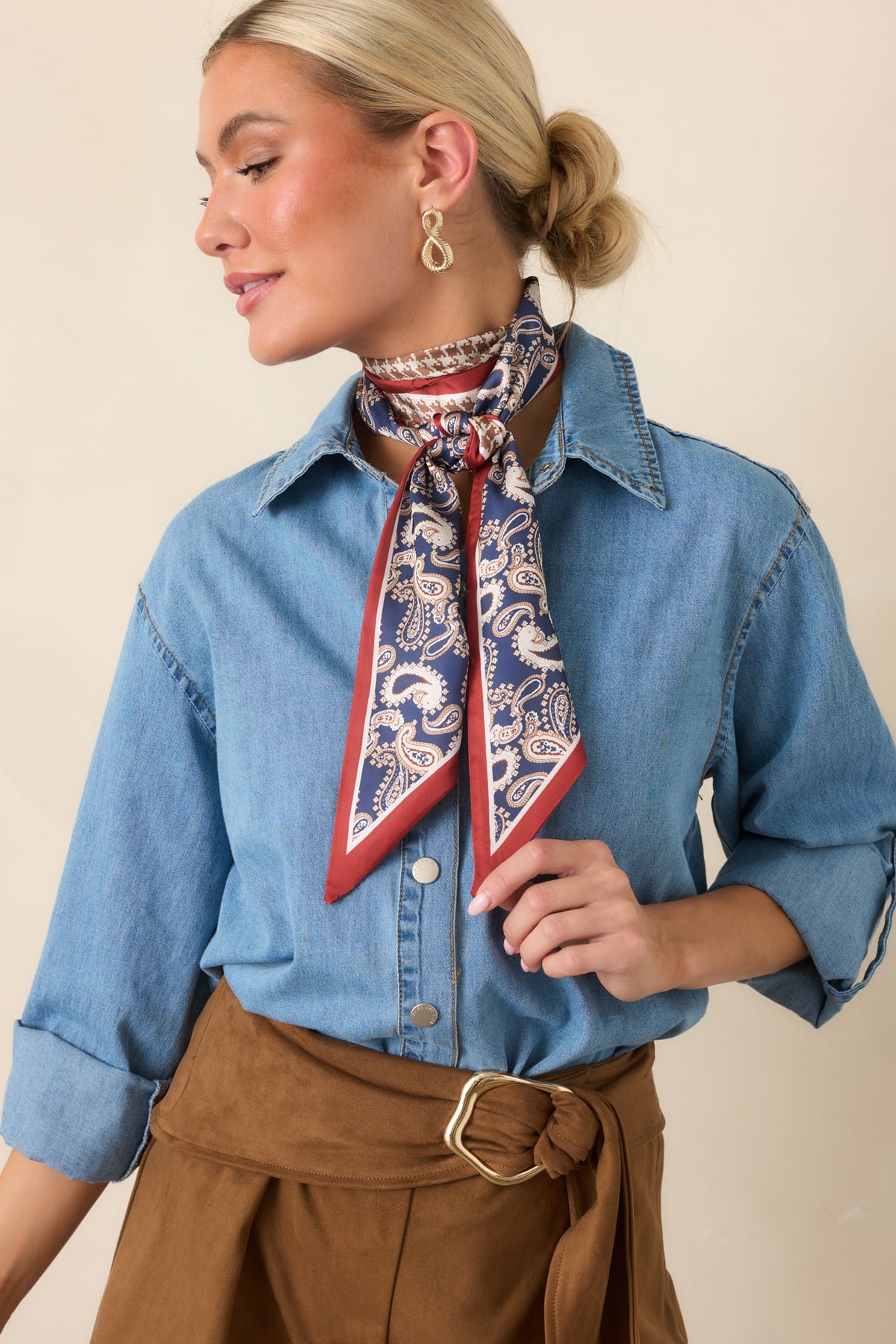 Soft cotton construction showcases the collared neckline, front buttons, and clean roll-tab sleeve detailing.