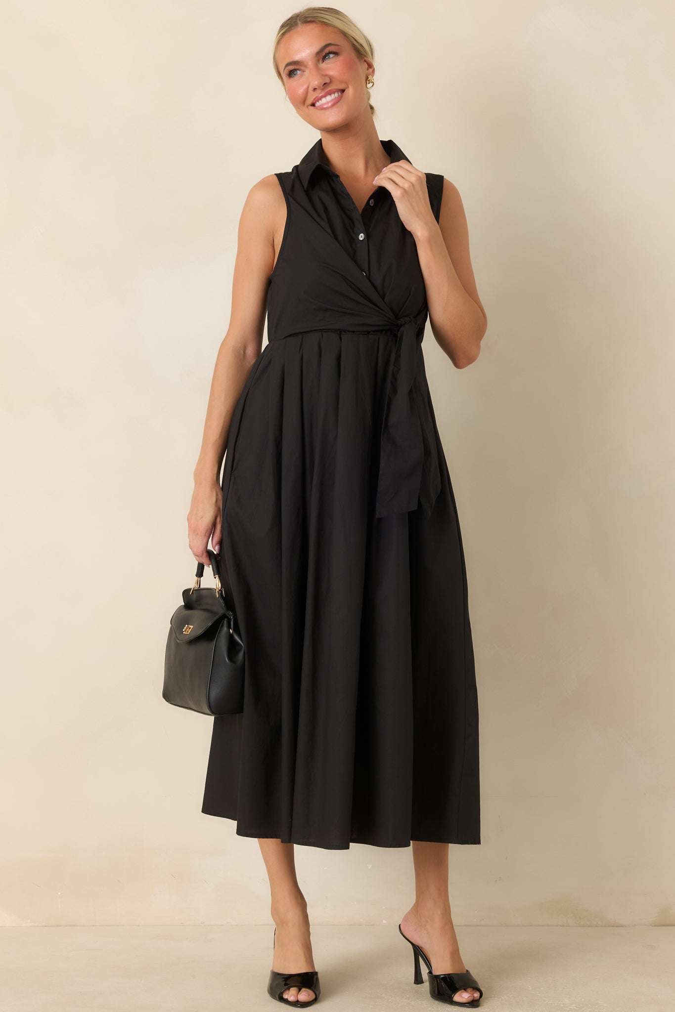 Soft cotton dress showcasing a faux wrap silhouette, waist tie detail, and graceful movement.