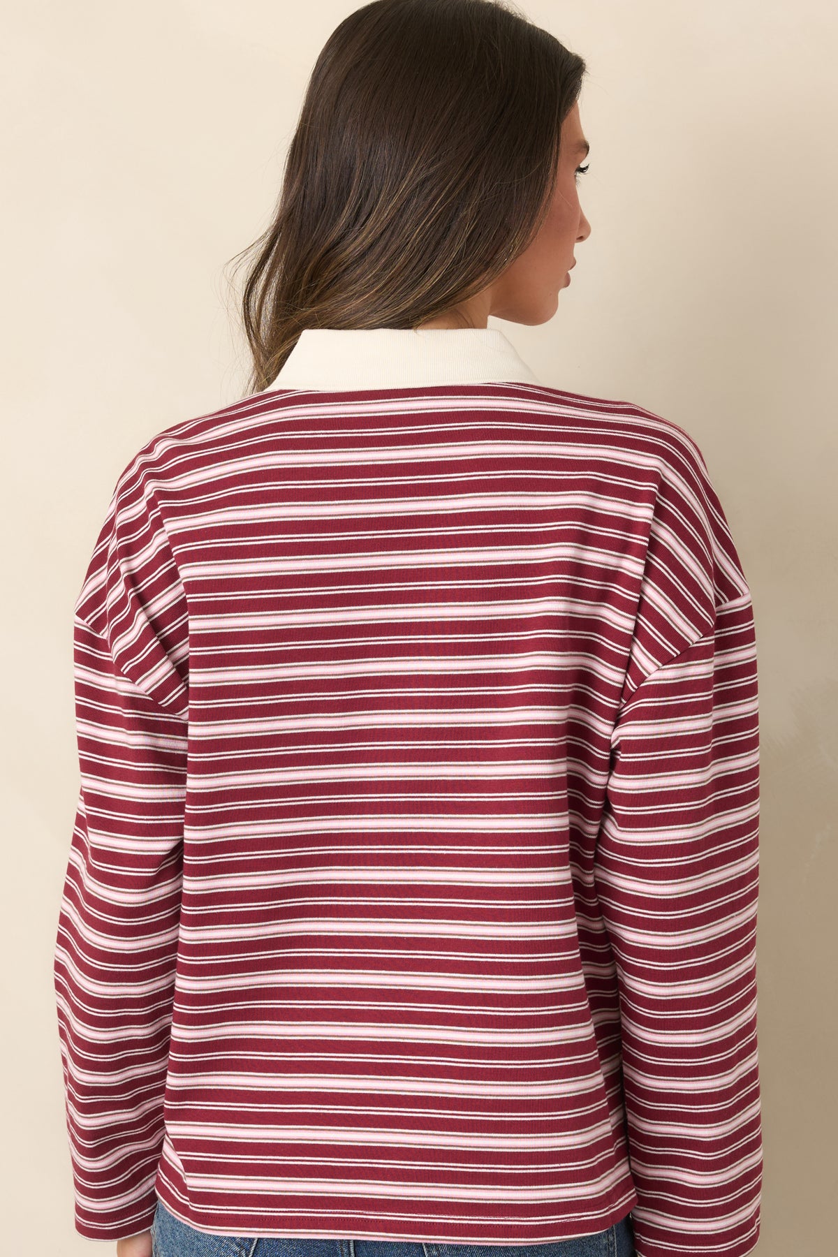 Rear of the soft cotton top displaying the ivory striped pattern, dropped shoulders, and relaxed silhouette.