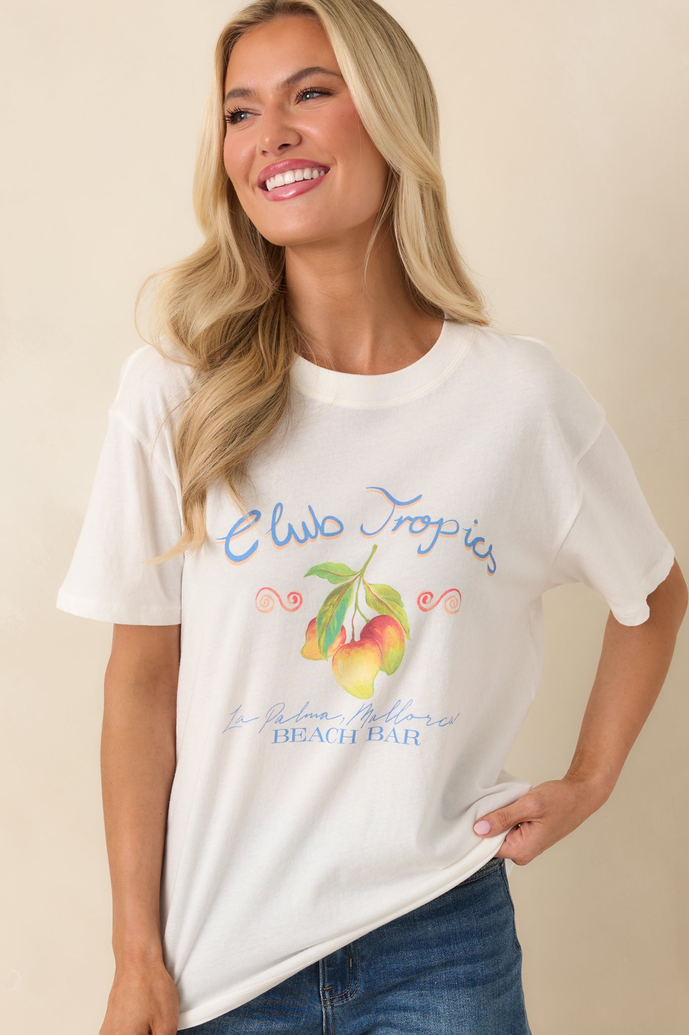 Soft cotton texture with vibrant “Club Tropics” print and relaxed drape detail.