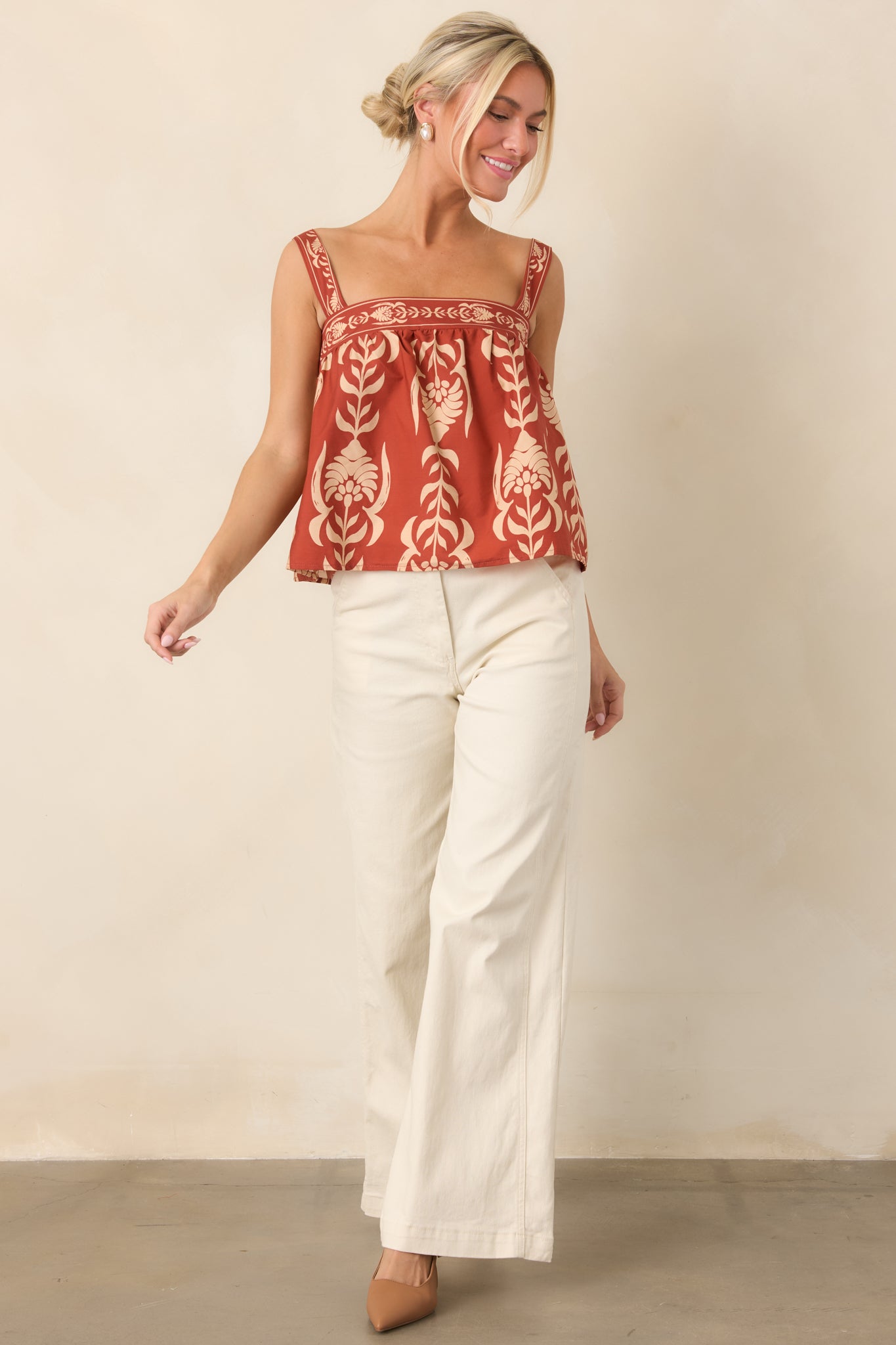 Soft cotton top showcasing a structured square neckline, broad shoulder straps, and a relaxed gathered babydoll shape.