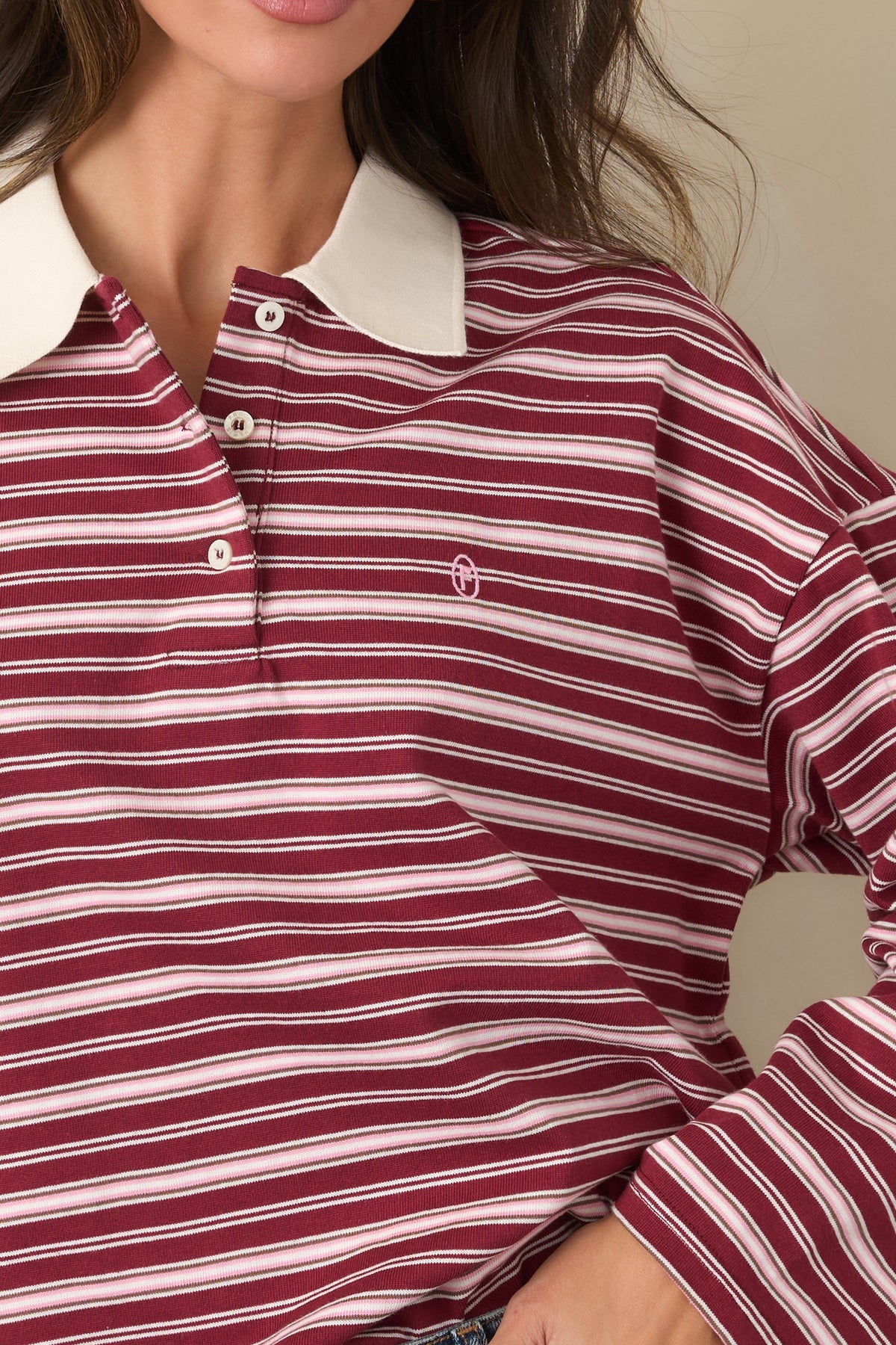 Detailed view of the soft cotton top featuring the ivory stripes, contrasting collar, and embroidered logo.