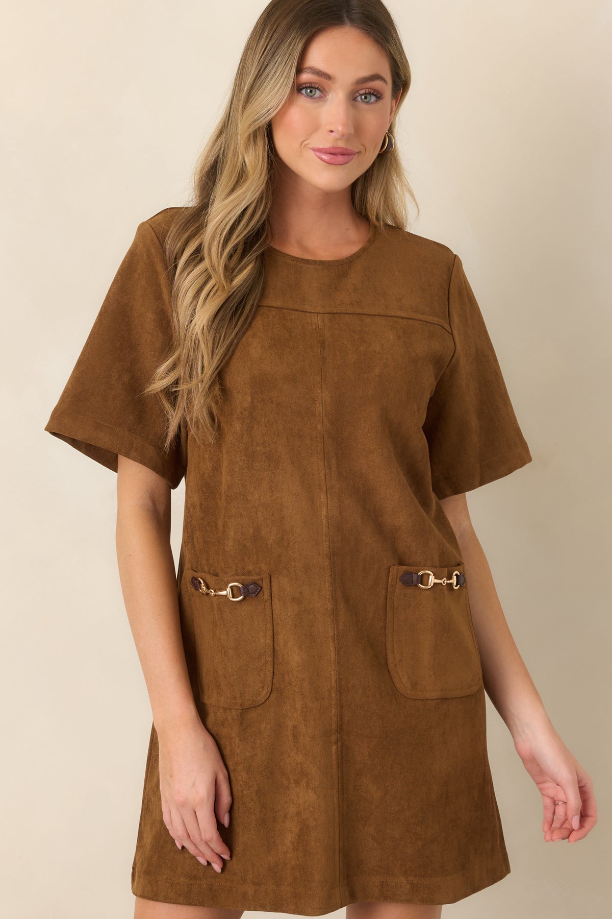 Soft faux suede mini dress with a smooth finish, round neckline, and short sleeves for a clean silhouette.