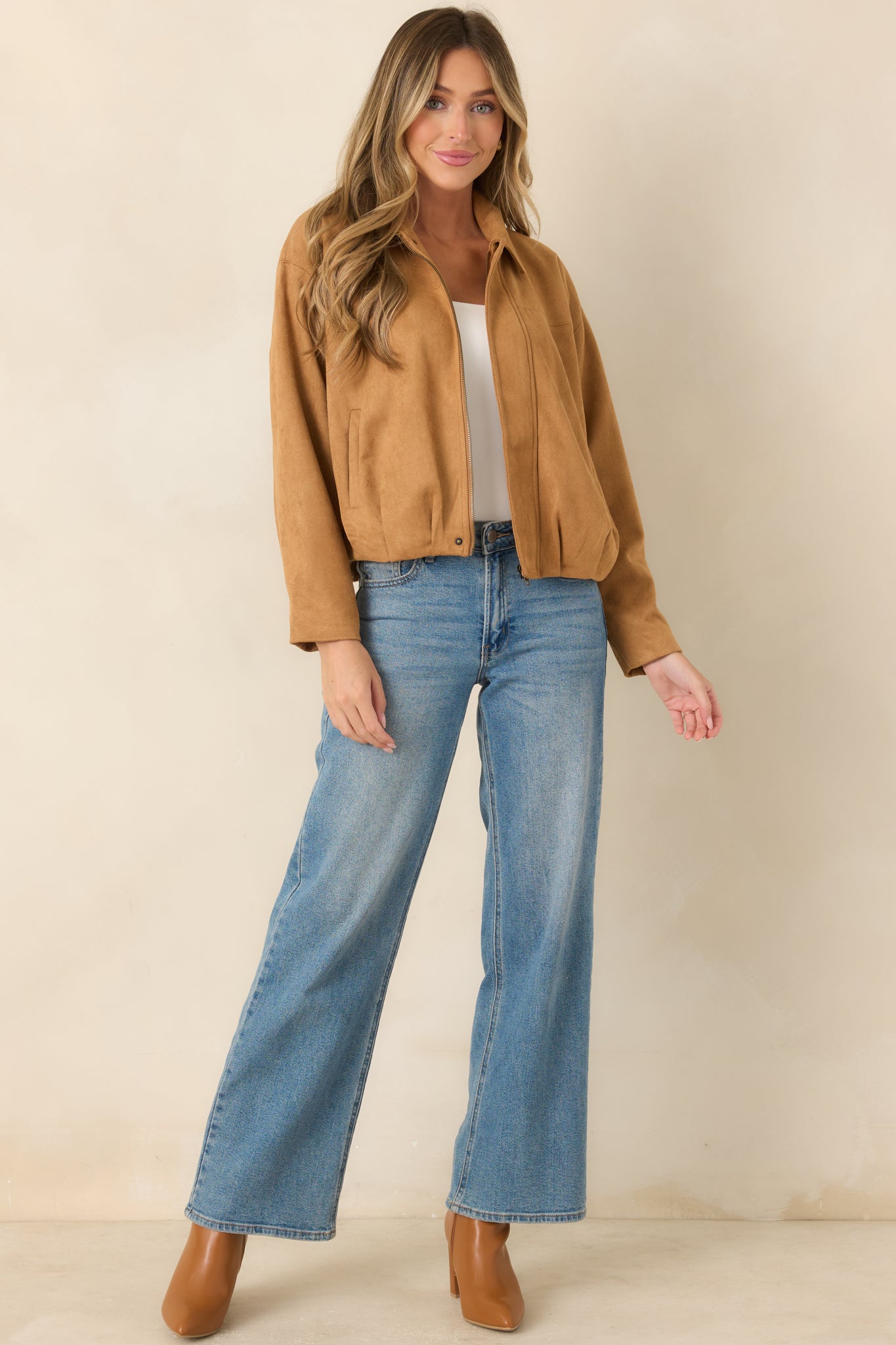 Soft faux suede jacket showcasing a pointed collar, clean concealed placket, subtle seam detailing, and an easy relaxed fit.
