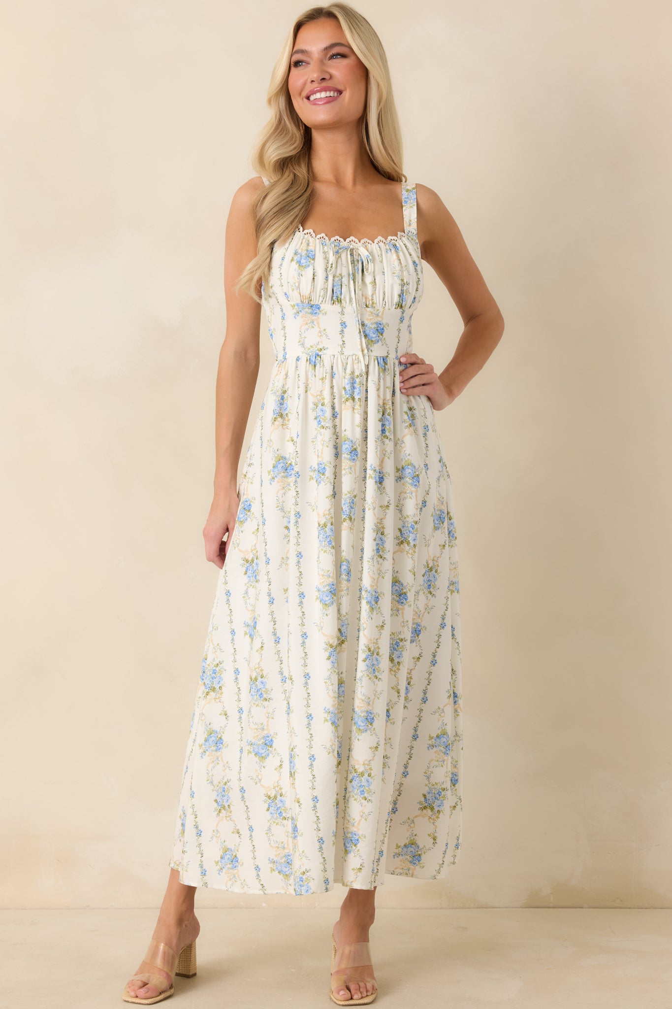 Soft floral midi dress with adjustable shoulder straps, textured ruching at the neckline, and a breezy midi-length hem.