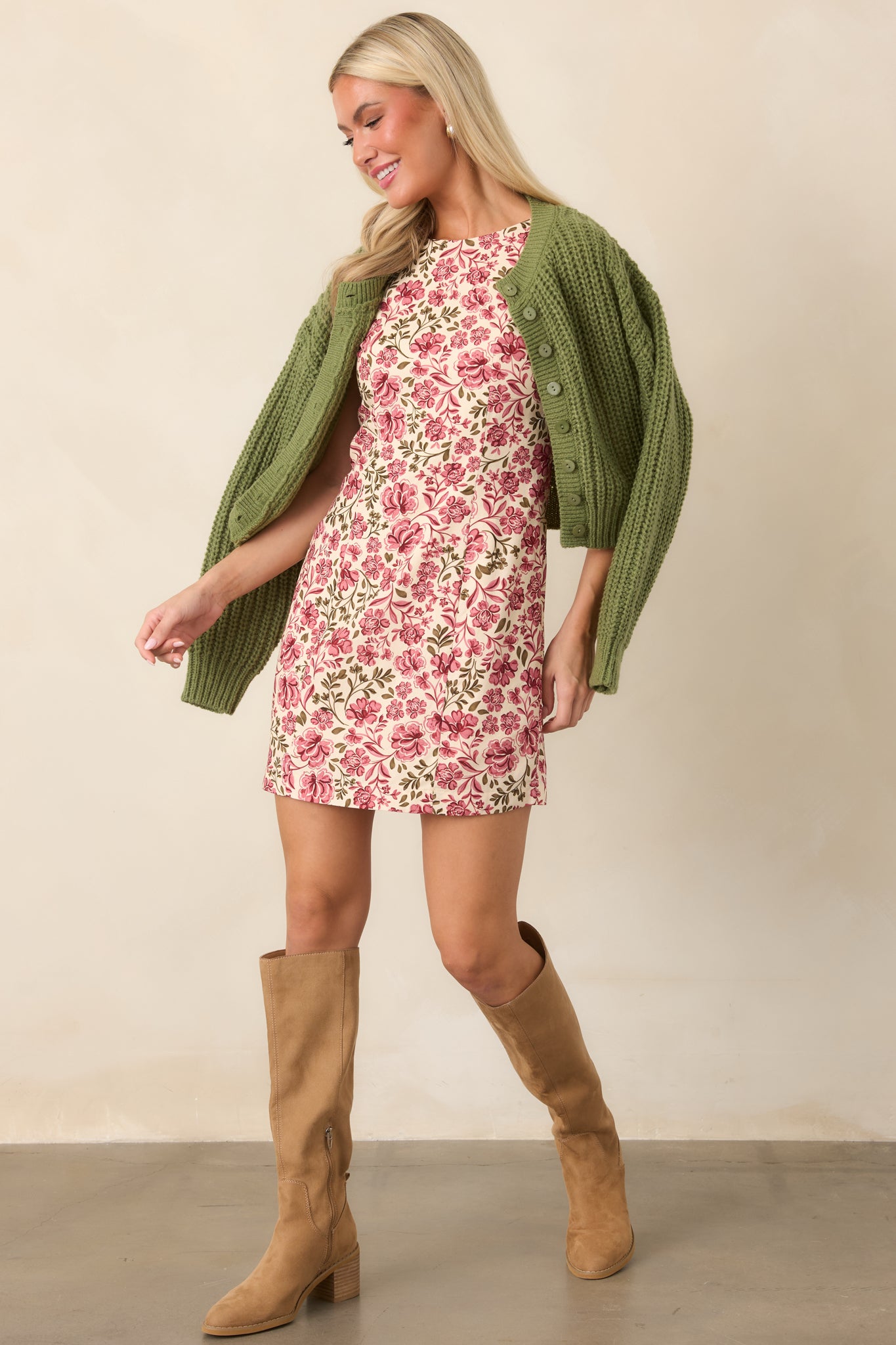 Soft green cardigan showcasing its chunky cable-inspired texture, full button front, cropped length, long sleeves, and ribbed hem.