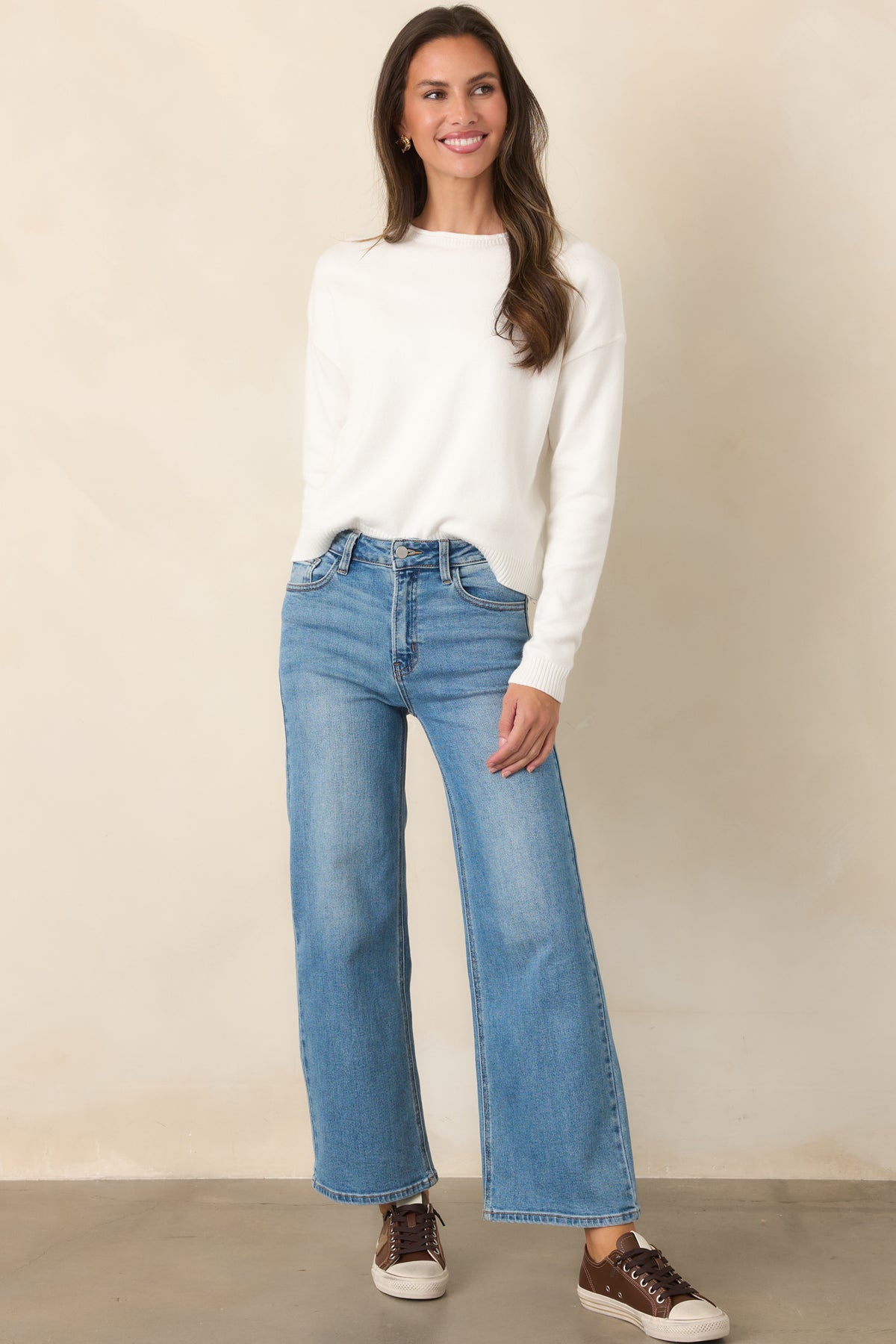 Soft ivory top with dropped shoulders, roomy long sleeves, and a classic ribbed crew neckline.