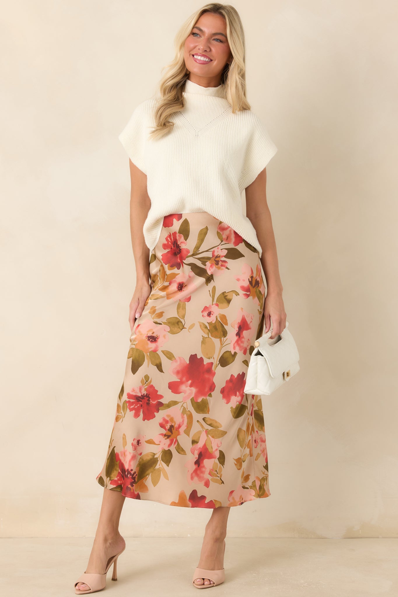 Soft ivory sweater crafted from textured ribbed knit with cap sleeves, a clean hemline, and a timeless polished design.