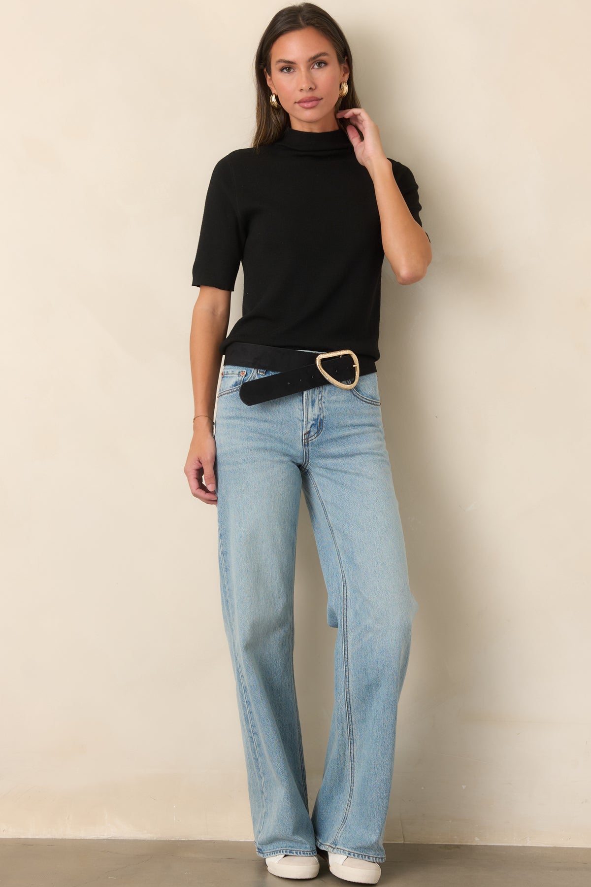 Soft knit top with a high turtleneck neckline, short sleeves, and a clean, streamlined silhouette.