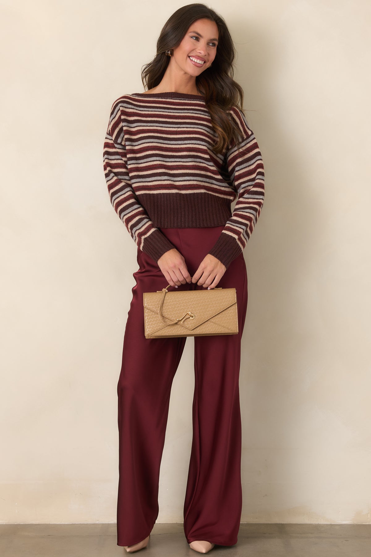 Soft knit top with a wide boat neckline, dropped shoulders, and long sleeves.