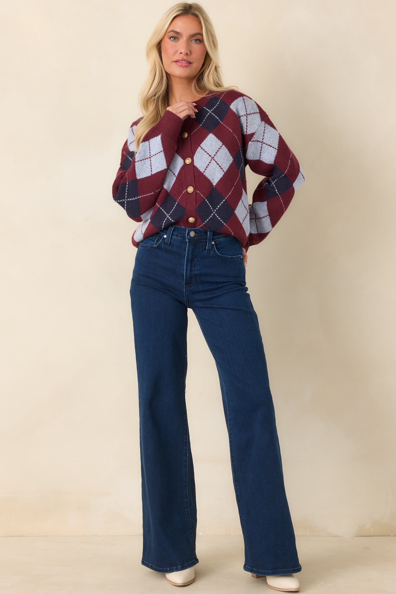 Soft knit cardigan showcasing colorful diamond accents, polished gold-tone buttons, and a comfortable fit.