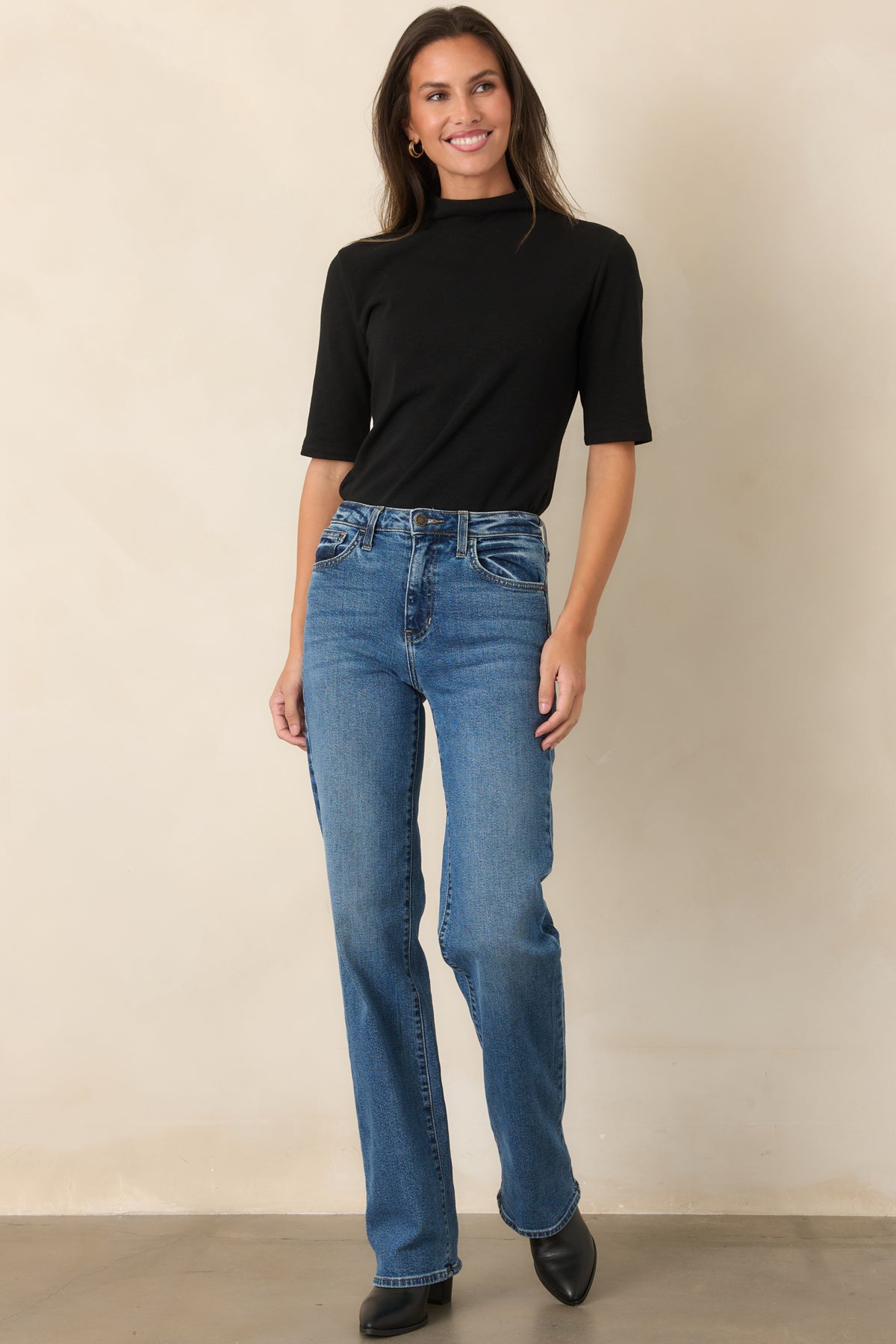 Soft knit top showcasing the high turtleneck and streamlined short-sleeve construction.
