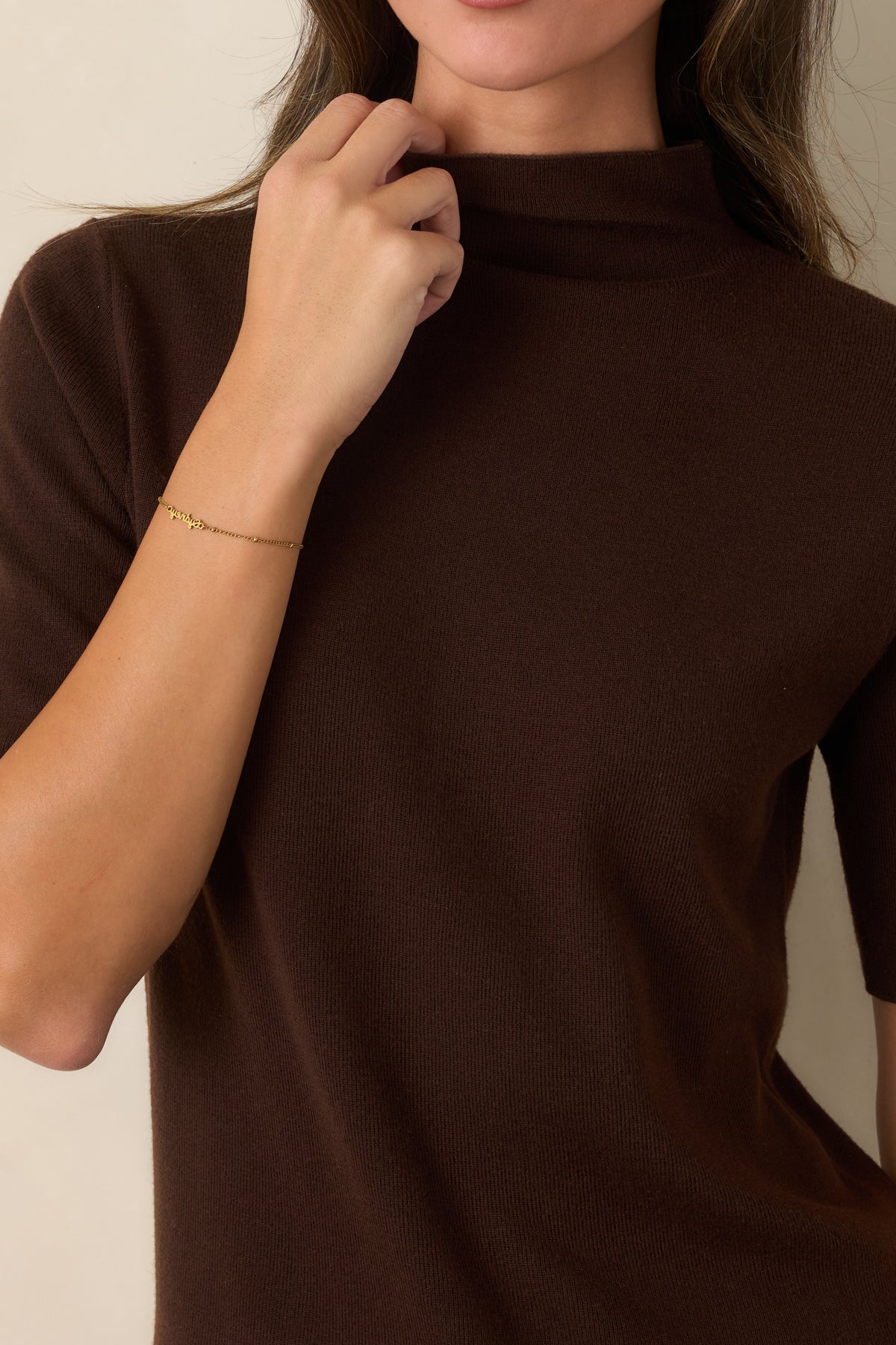 Close-up detail highlighting the soft knit texture and high turtleneck neckline.
