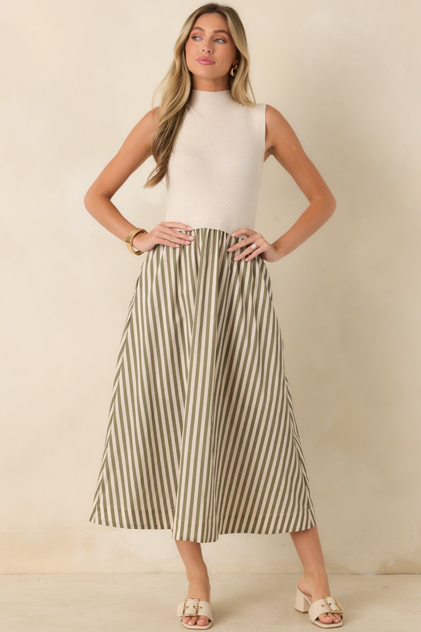 Soft knit midi dress with a polished mock neckline, textured design, and flowing full skirt accented with calming sage green stripes.