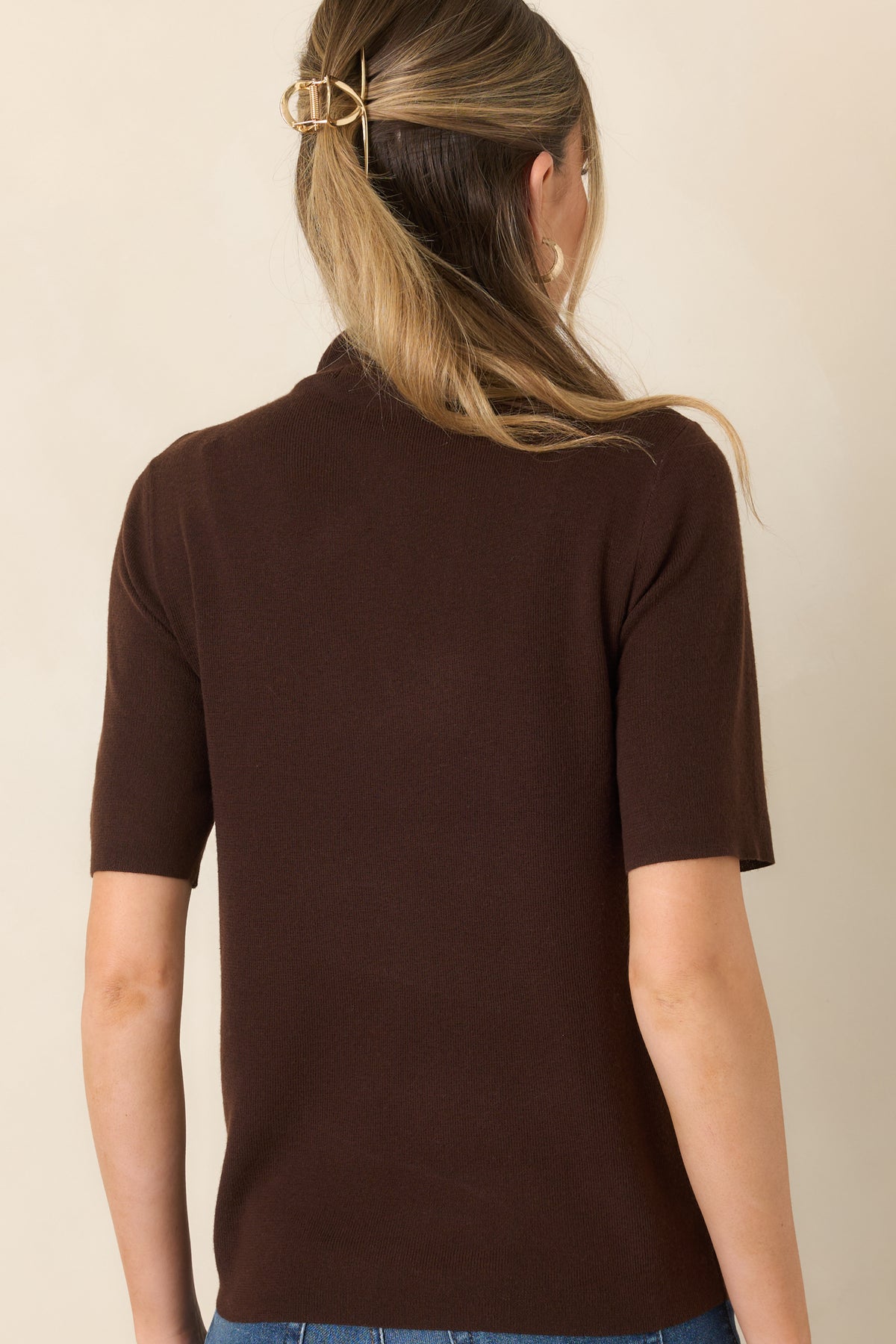 Rear of the soft knit short sleeve top showing the clean construction and streamlined silhouette.
