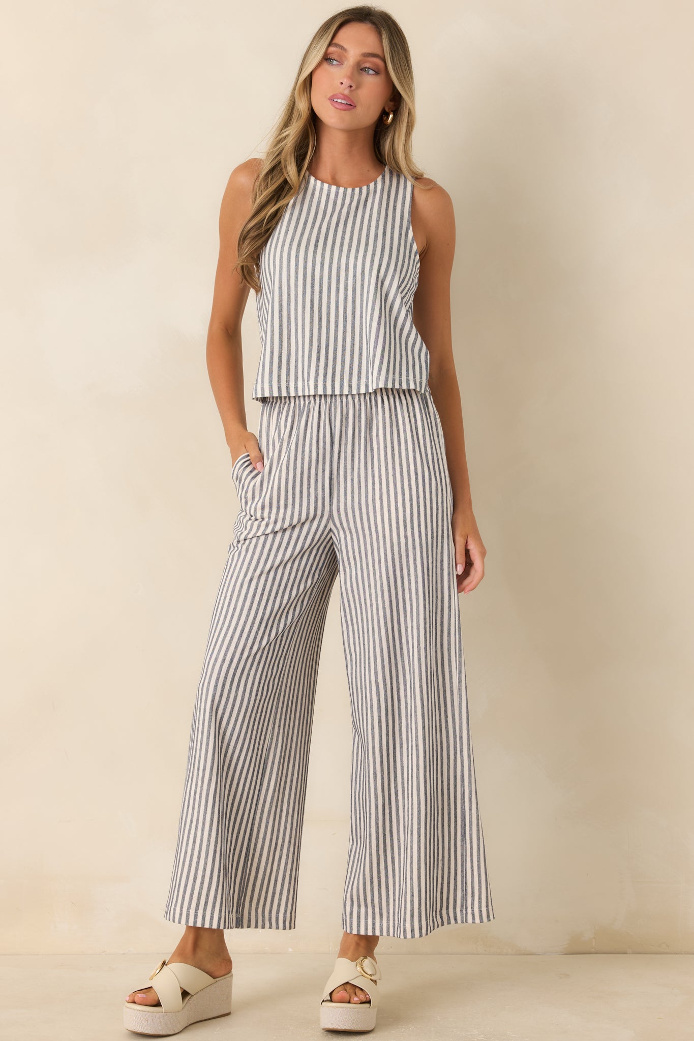 Soft knit sleeveless top featuring classic vertical stripes, a round neckline, and relaxed silhouette.