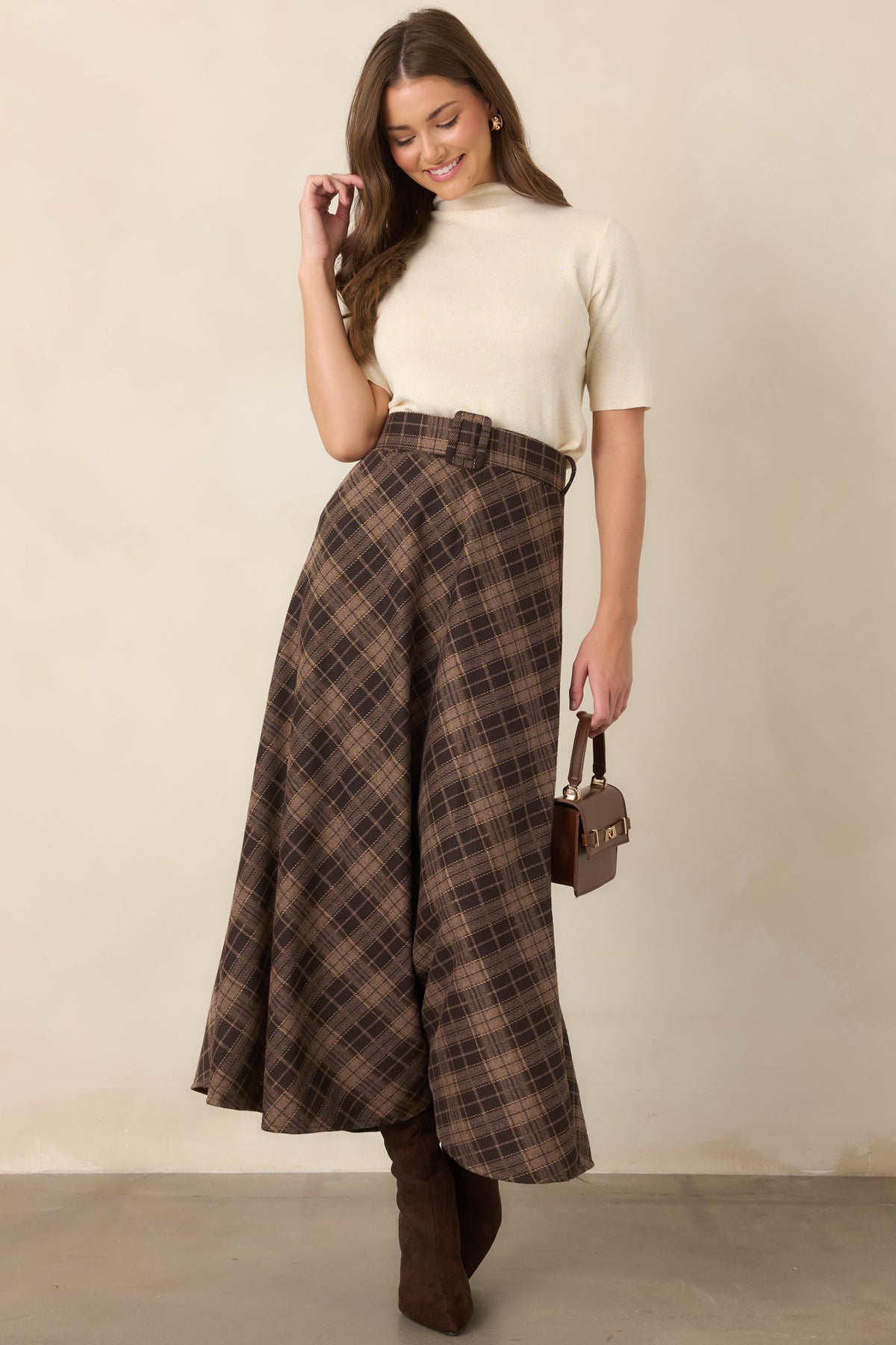 Soft knit top designed with a streamlined shape, high turtleneck neckline, and short sleeves.