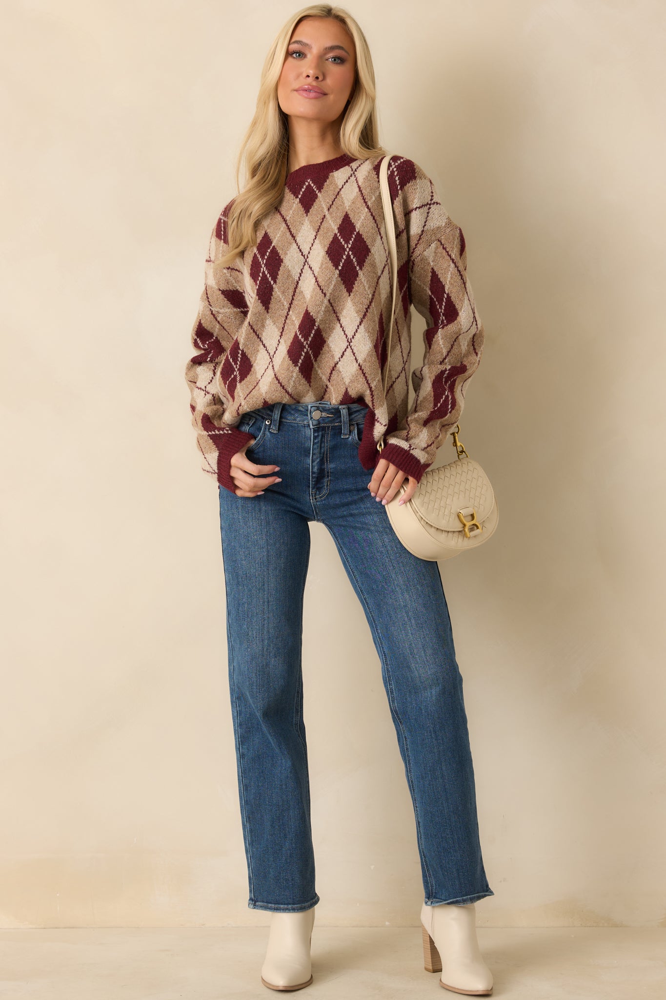 Soft knit sweater highlighting the allover argyle pattern in coordinating neutral tones.
