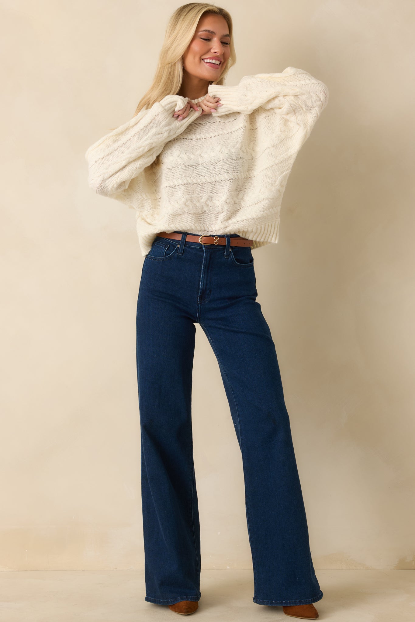 Soft knit sweater displaying ribbed cuffs and hem with structured finish.