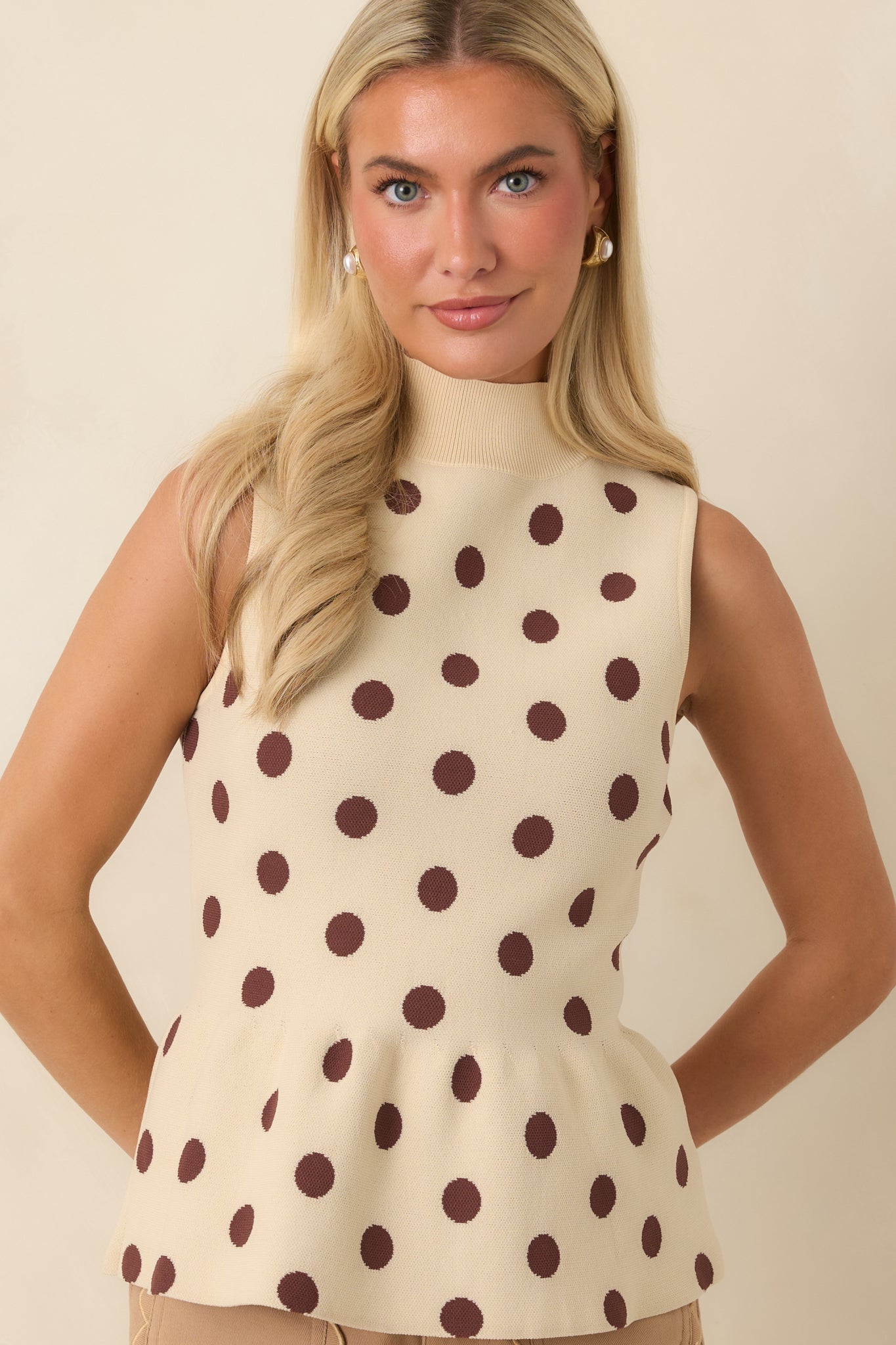 Soft knit top detail featuring the playful polka dot design and structured mock neckline.