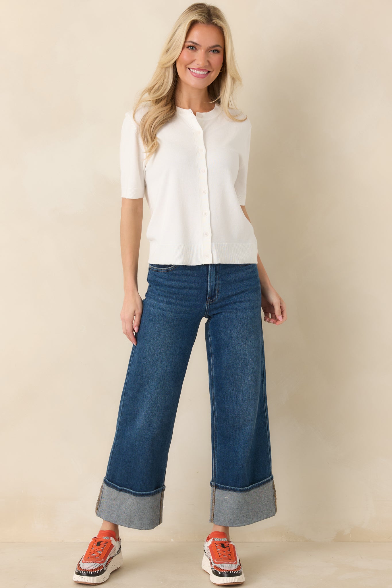 Soft knit top with short sleeves and clean button-front silhouette.